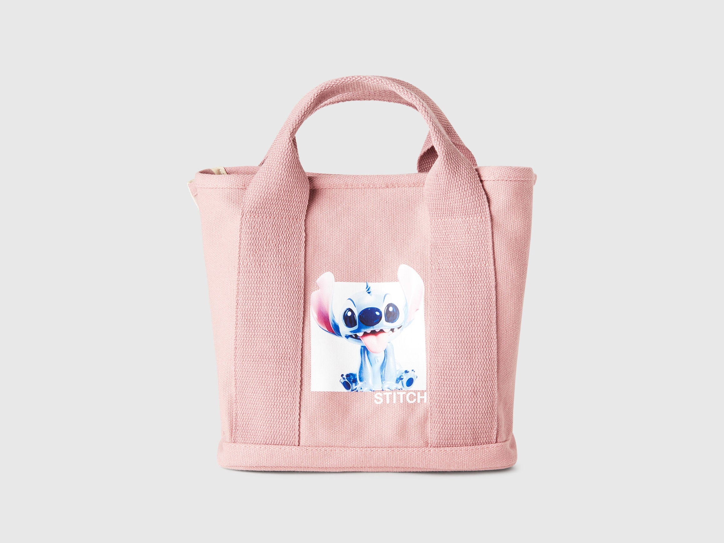 Front view of a pink Benetton x Lilo & Stitch Disney tote bag, featuring a clear graphic of Stitch, perfect for fans.