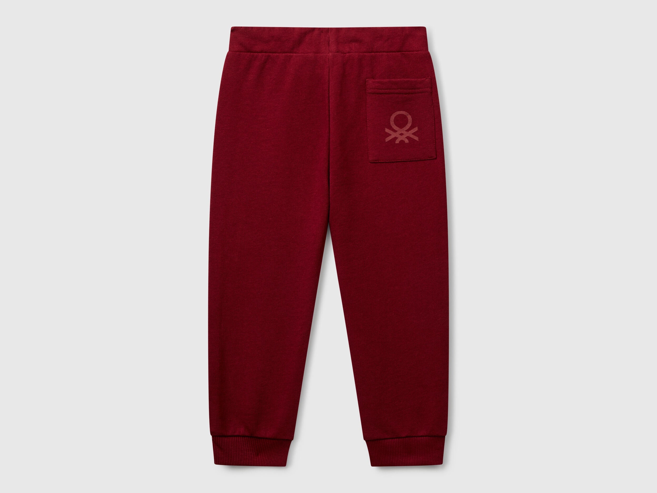 Back view of Benetton logo print trousers with certified organic detail