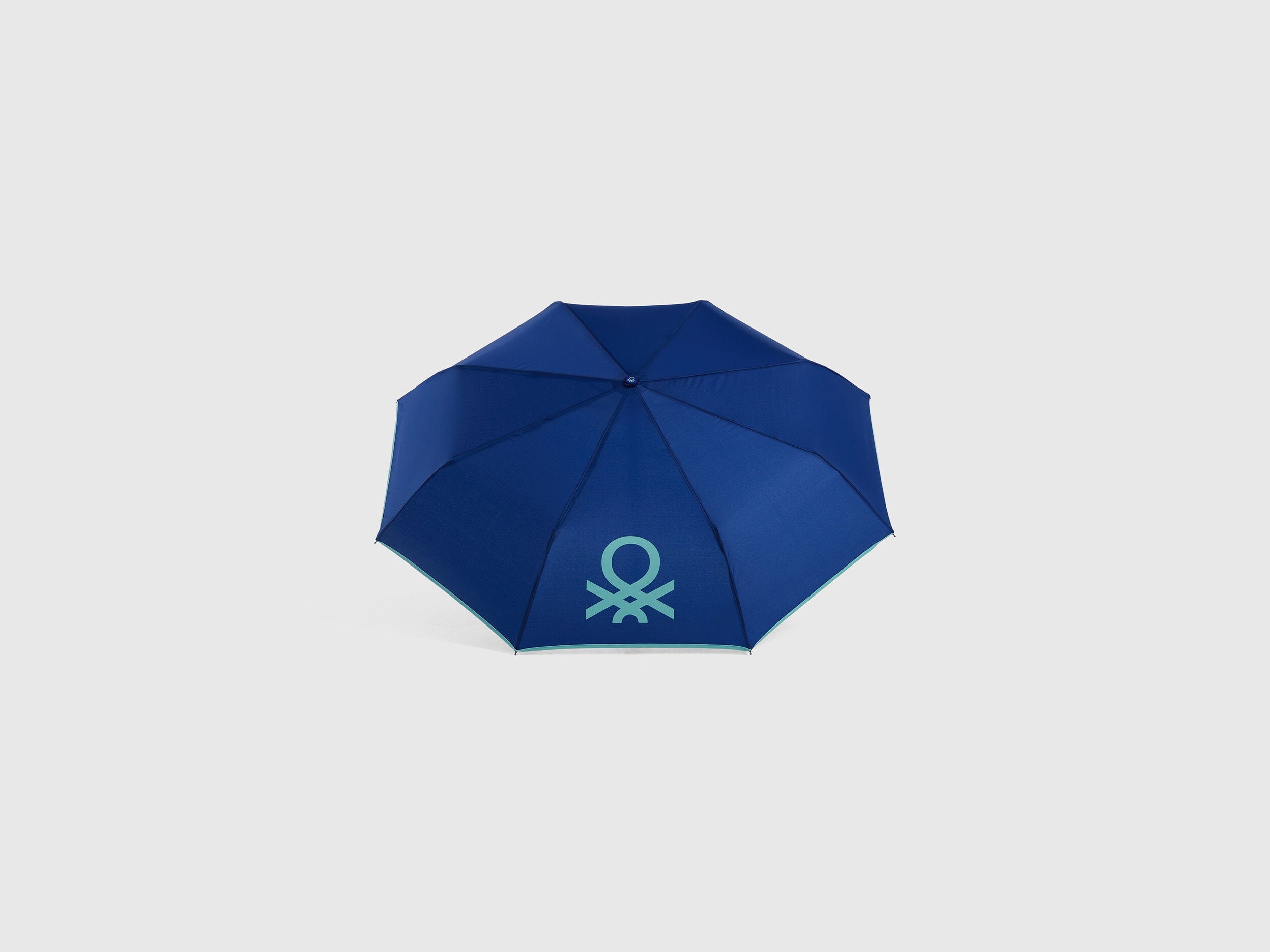A closed blue umbrella, showcasing its compact and portable design.