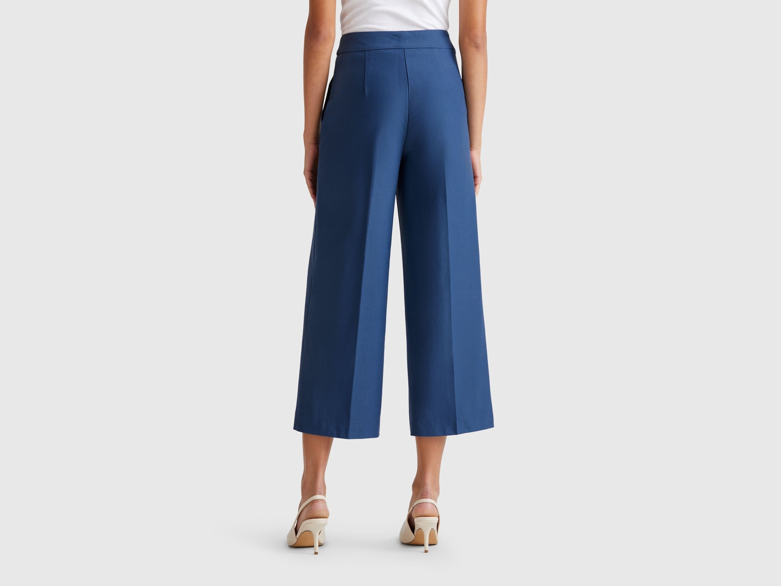 Back view of a female model wearing blue women&