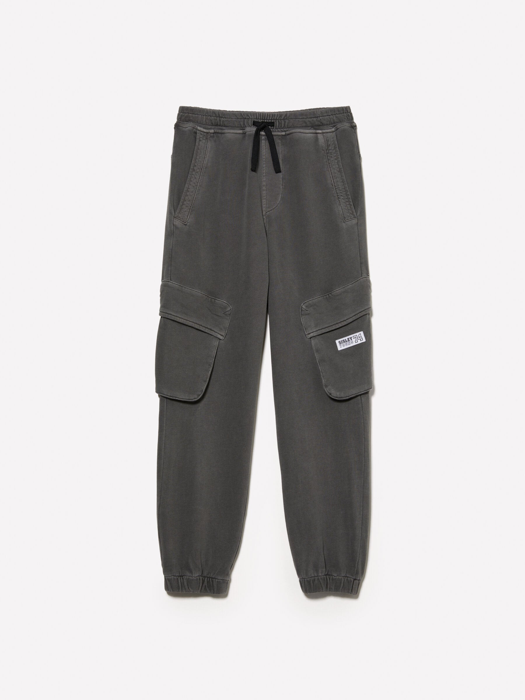 Front view of dark grey joggers with functional cargo-style pockets on the sides and an adjustable drawstring waist, a versatile choice for loungewear or active wear in Kuwait.