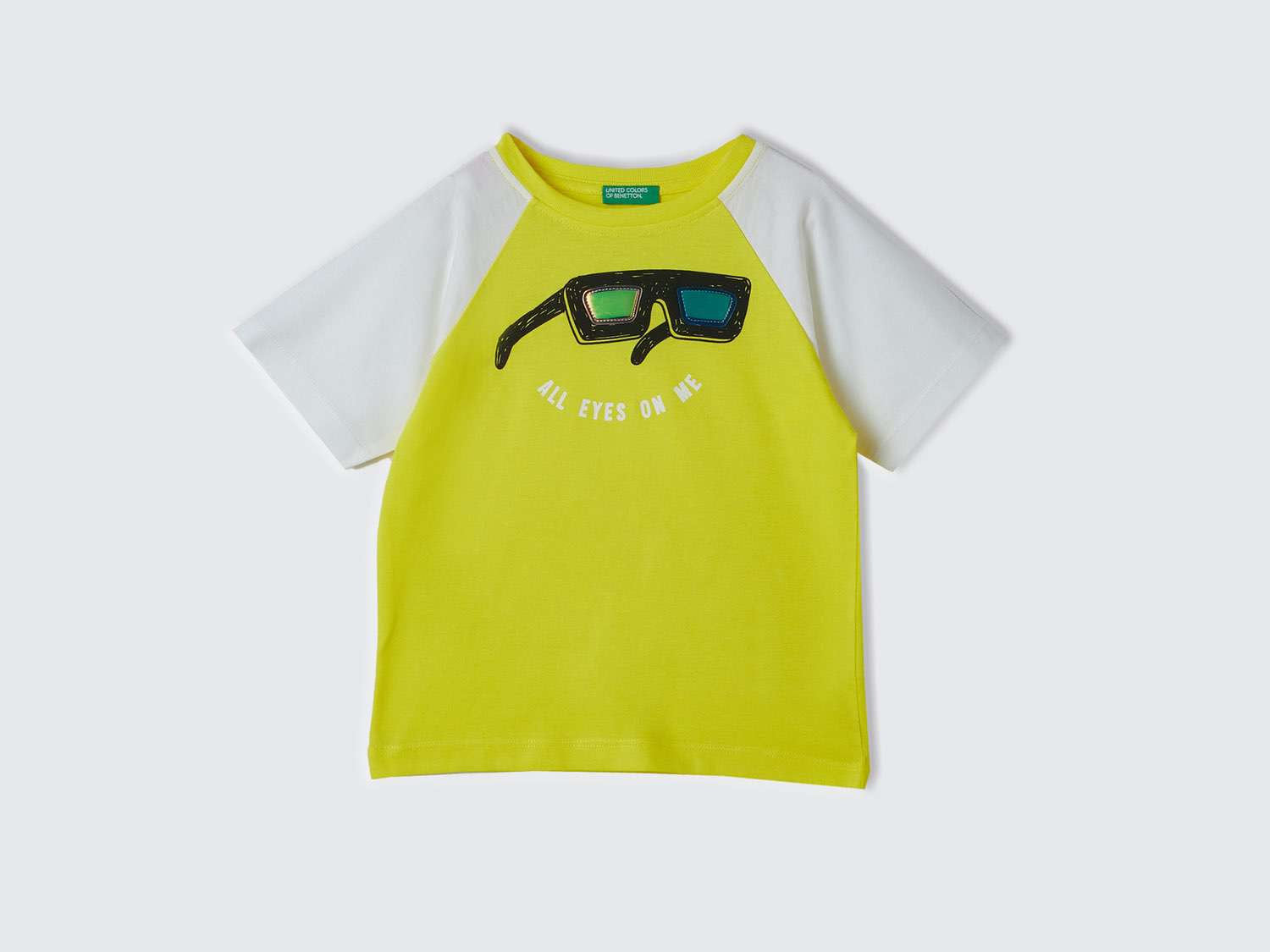 Front view of a yellow and white t-shirt for kids in Kuwait, with "All Eyes On Me" graphic.