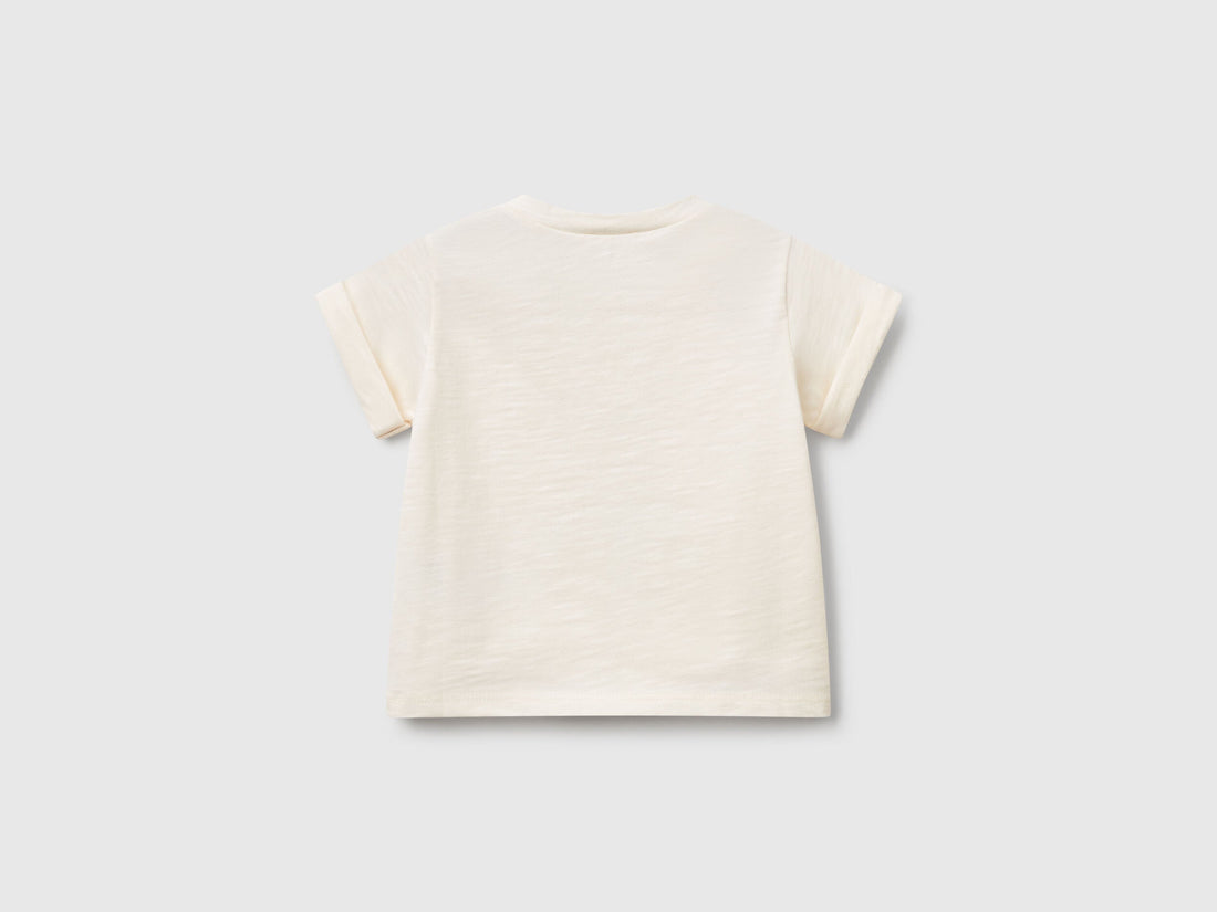 Back view of an off-white short-sleeve T-shirt for kids in Kuwait, showing its plain design and comfortable fit, ideal for everyday play.