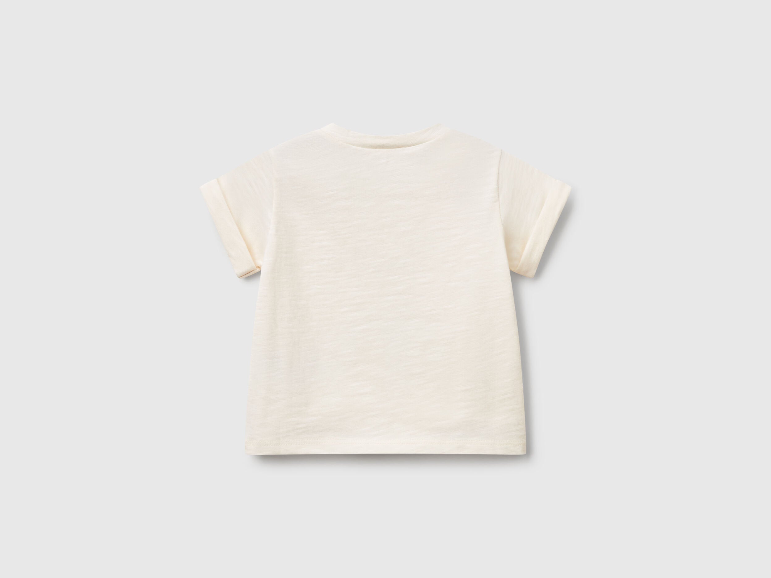 Back view of an off-white short-sleeve T-shirt for kids in Kuwait, showing its plain design and comfortable fit, ideal for everyday play.