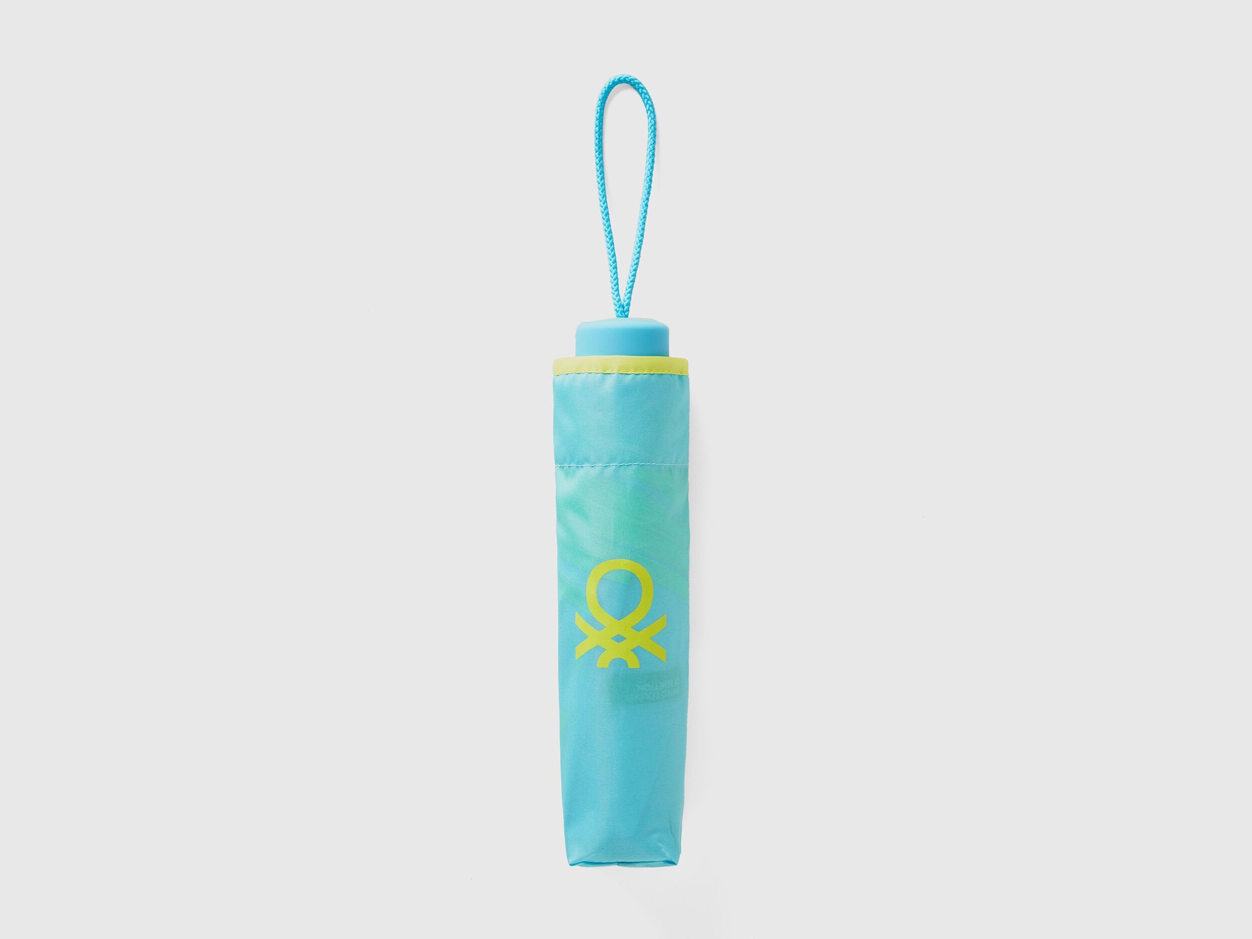 Folded light blue Benetton umbrella, compact and portable.