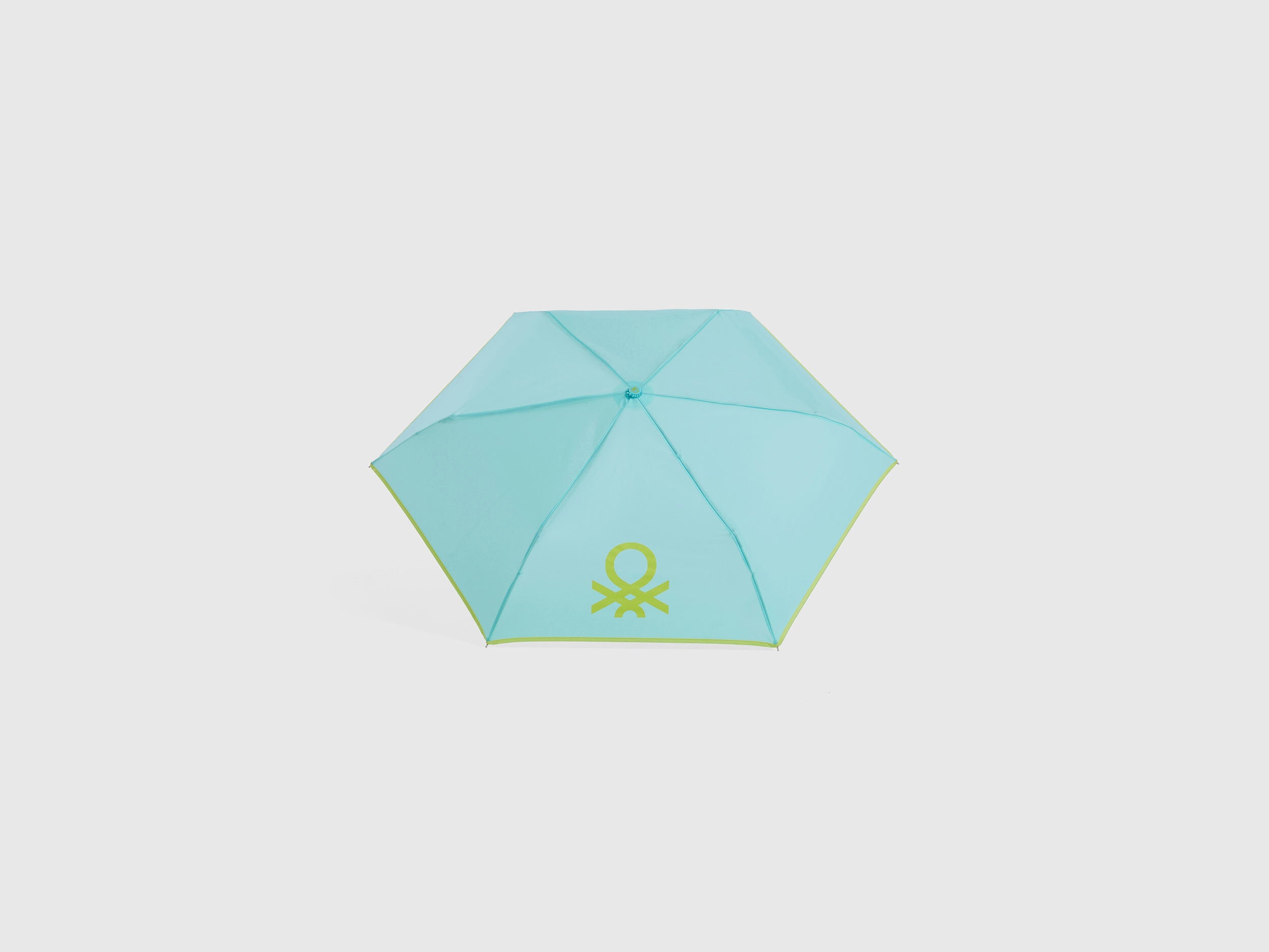 Open light blue Benetton umbrella, top view for rain protection.
