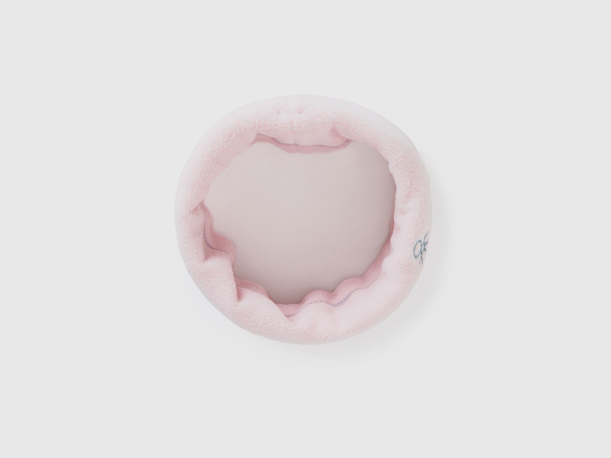 Light pink fleece neck warmer, rolled for soft comfort.