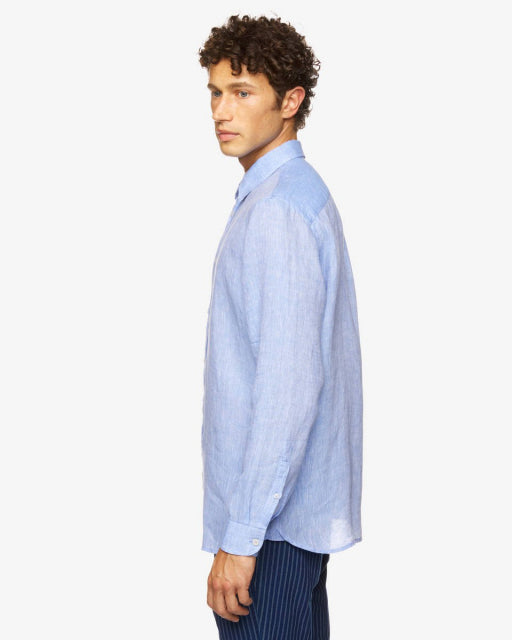 Side profile of a male model wearing a light blue long-sleeve linen shirt, ideal for the climate in Kuwait. This linen shirt in Kuwait offers breathability and style.