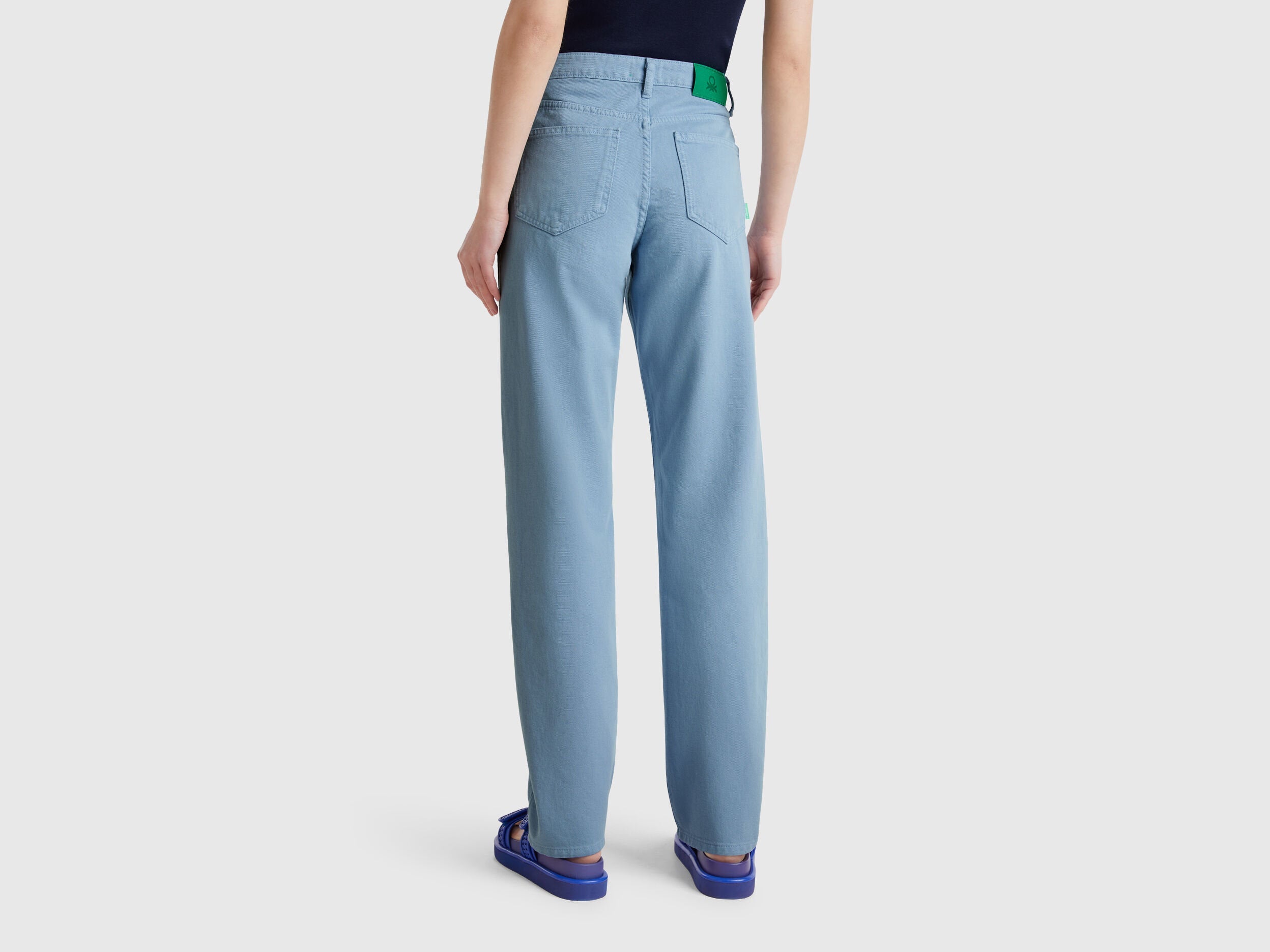 Black flat lay of light blue women straight leg jeans in blue colour, showcasing the full-length and clean lines, a versatile wardrobe staple in Kuwait.