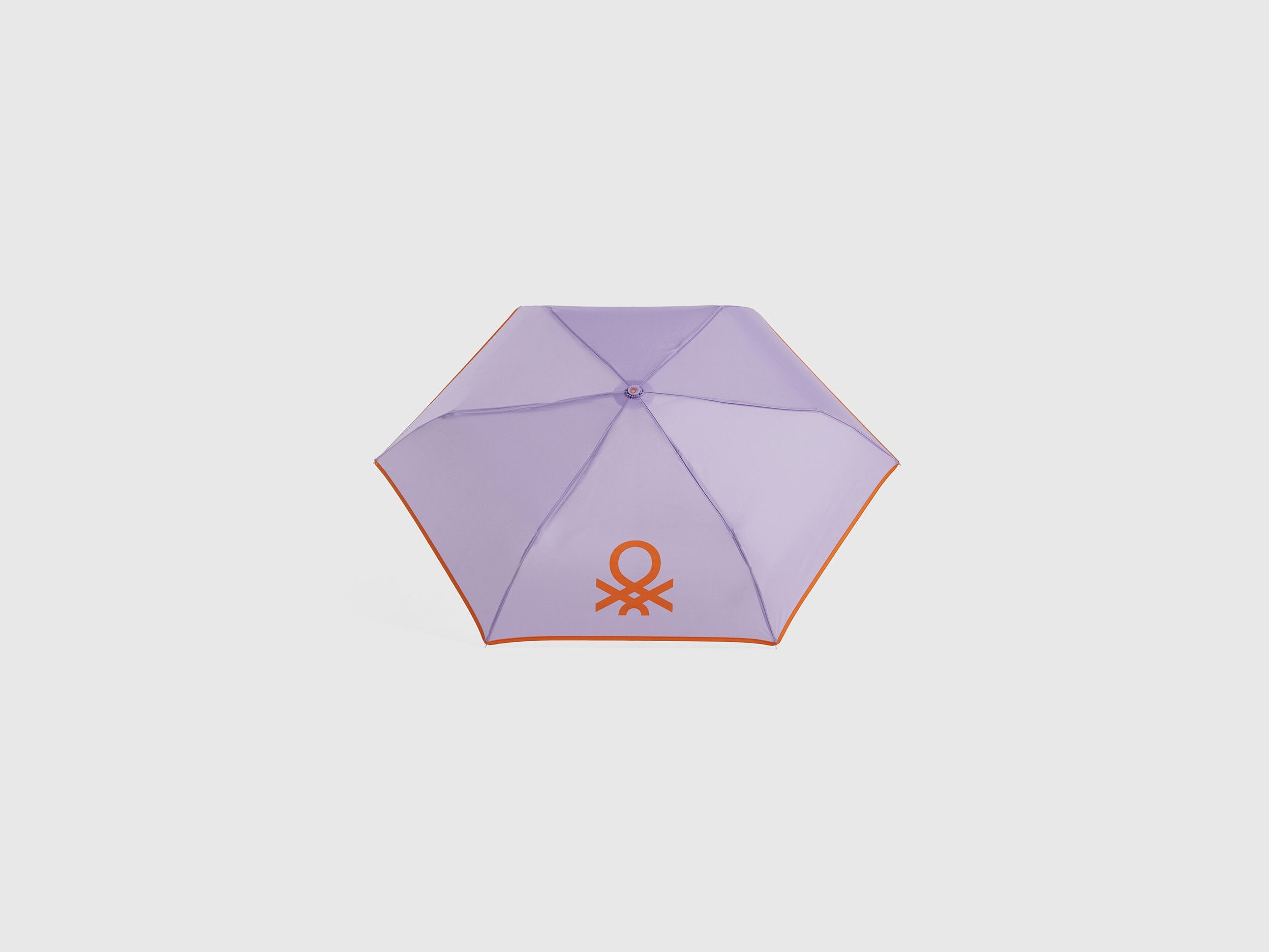 Open lilac Benetton umbrella, top view for rain protection.