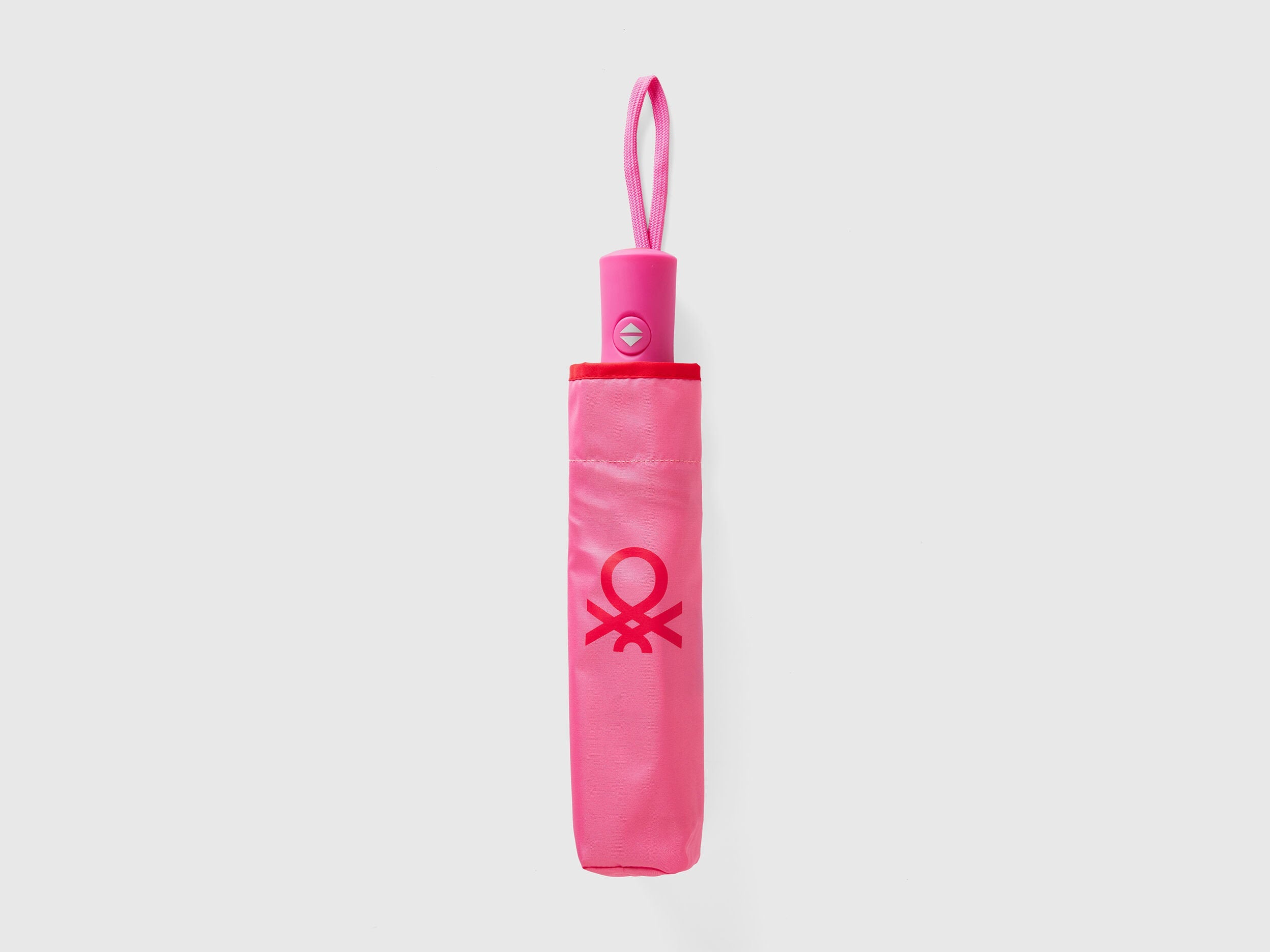 Folded pink Benetton umbrella, compact for rainy days.