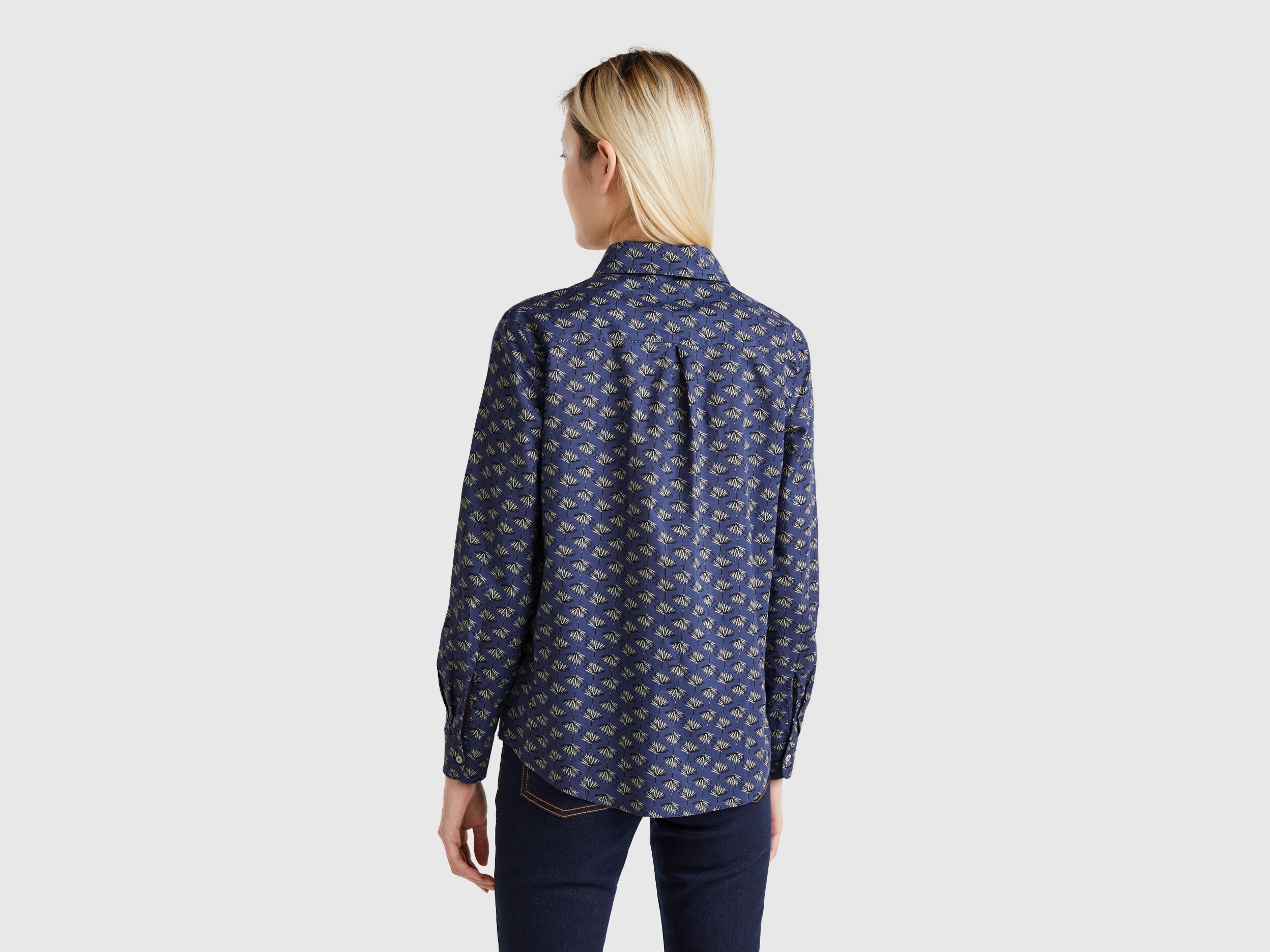 Back view of a dark blue patterned shirt for women, for sale in Kuwait.