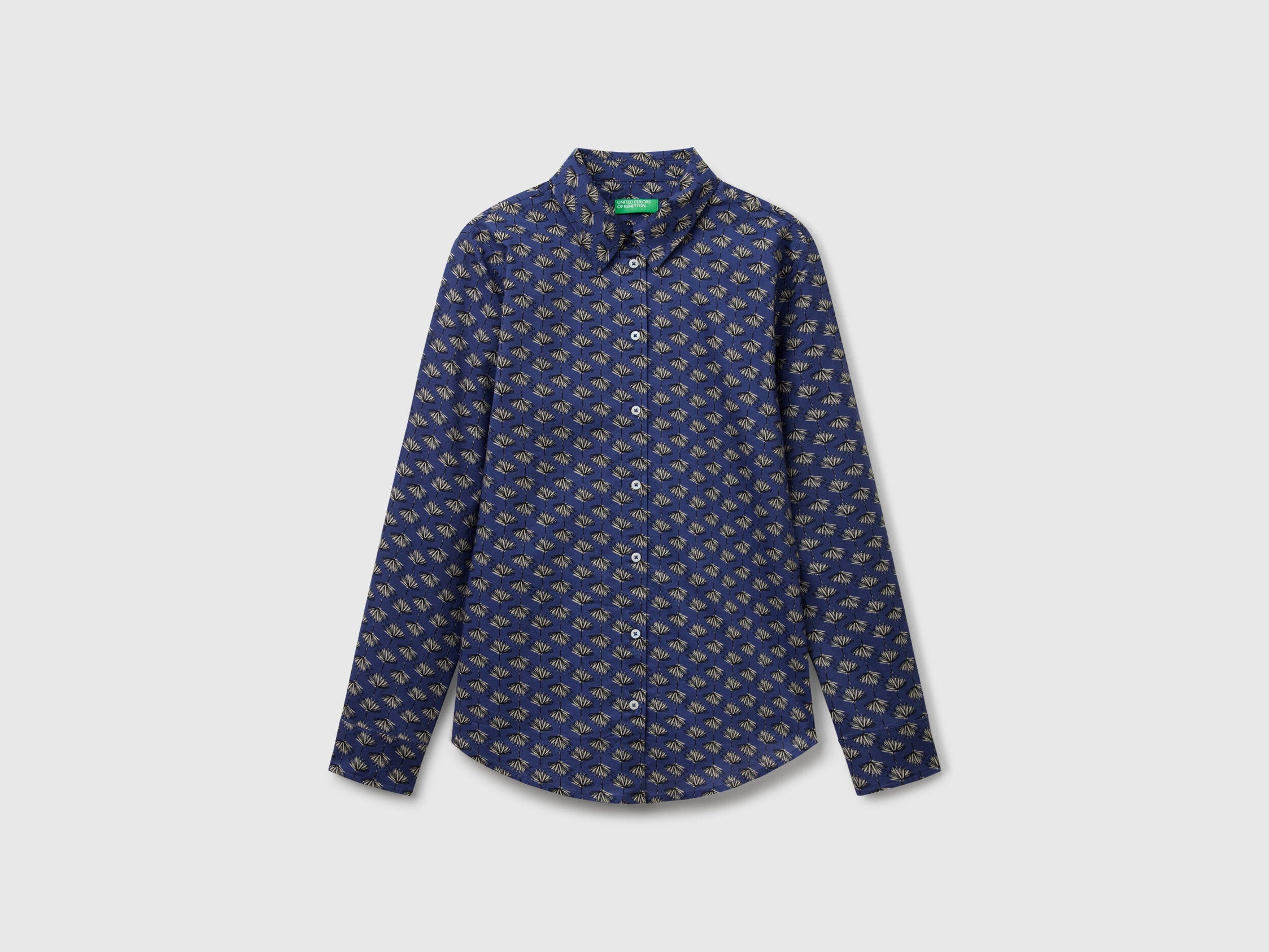 Flat front view of a dark blue patterned shirt for women, popular in Kuwait.