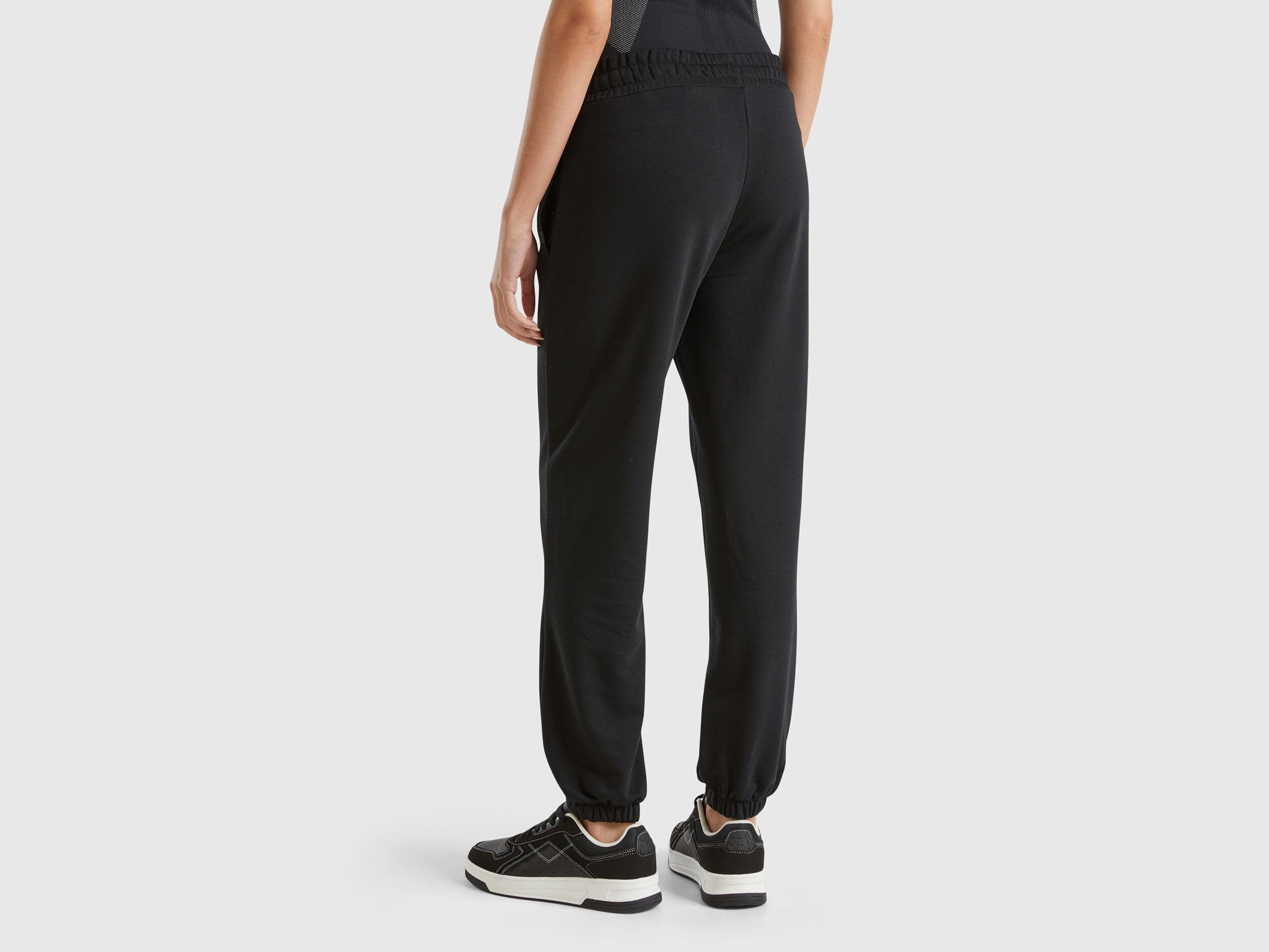 Close-up of the textured fabric and elastic drawstring waistband of black women&