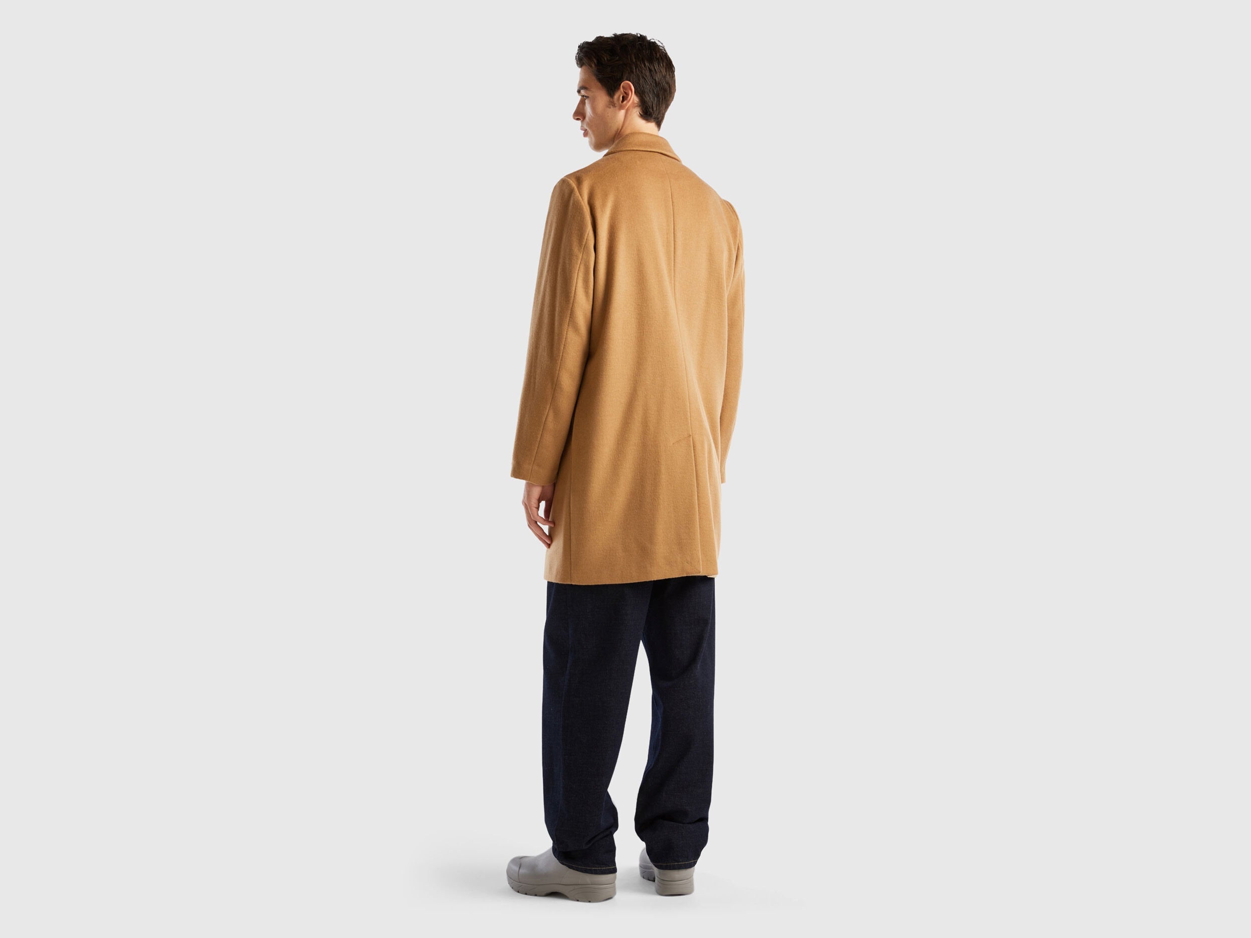 Back view of a male model wearing a beige men&