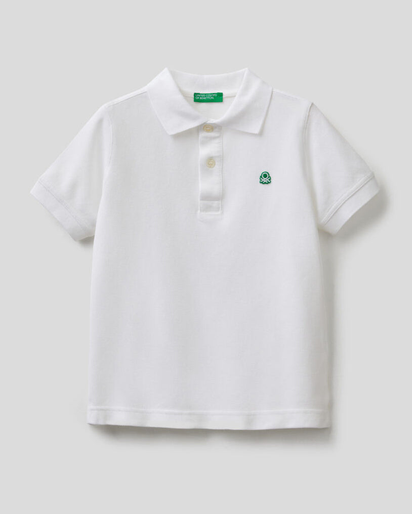 Front view of a white polo shirt for boys in Kuwait, with short sleeves.