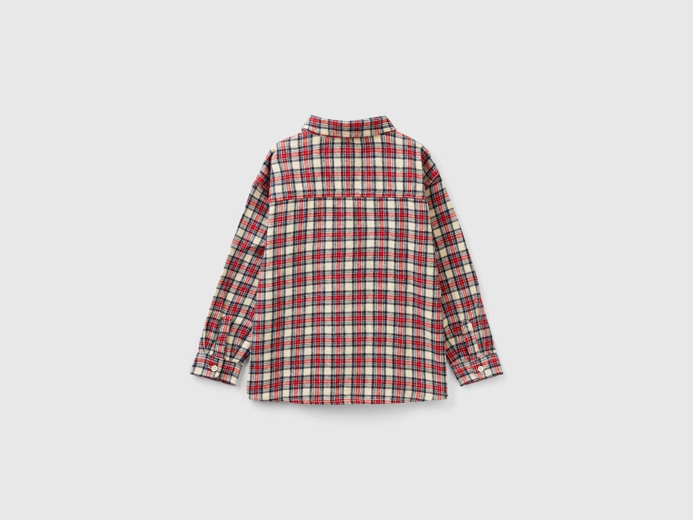 A close-up of a neatly folded checked shirt for boys, highlighting the woven pattern and fabric texture, a popular style in Kuwait.