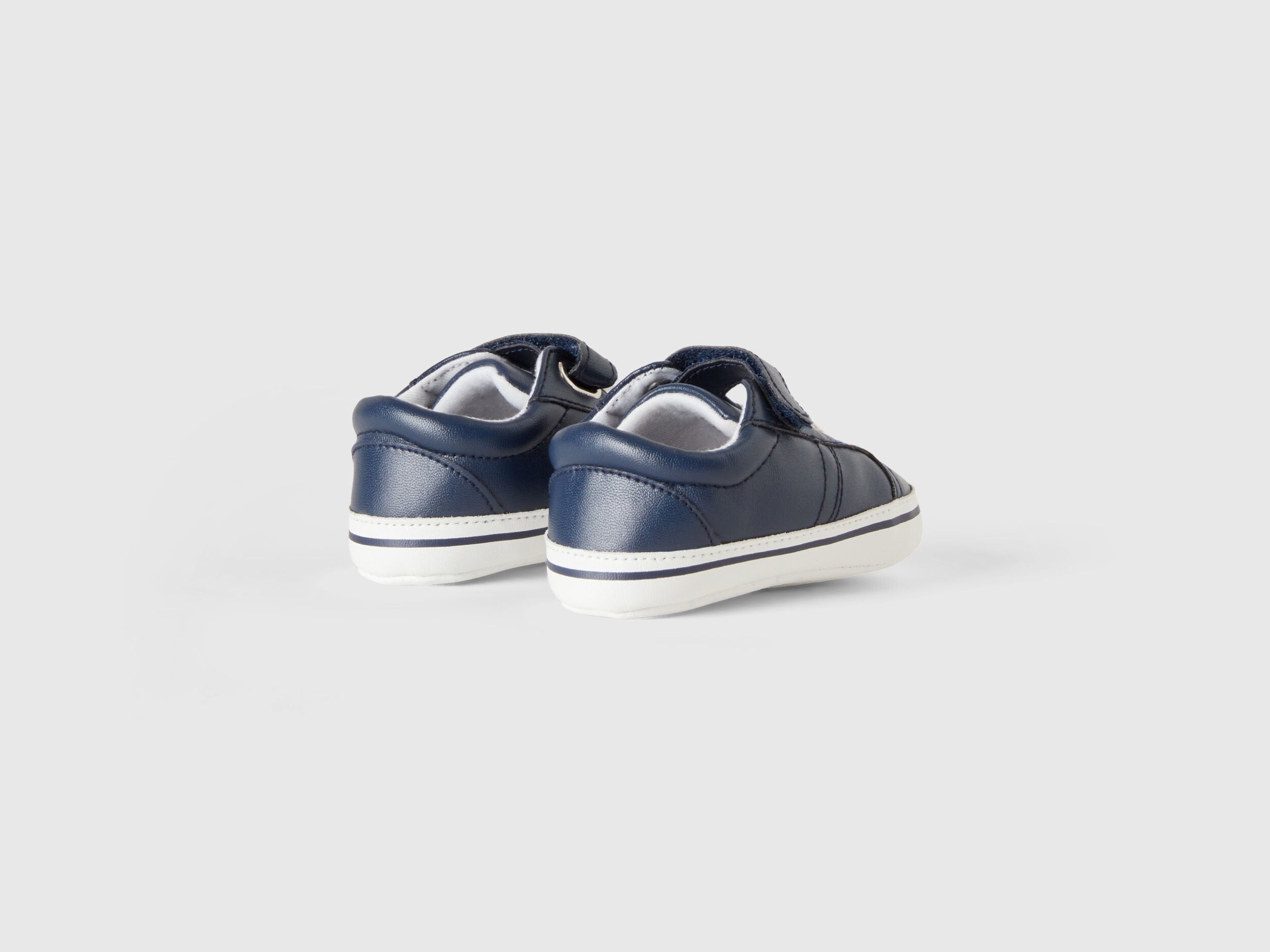 Back view of a pair of first-step kids shoes with white soles, showing the stable design for active toddlers in Kuwait.