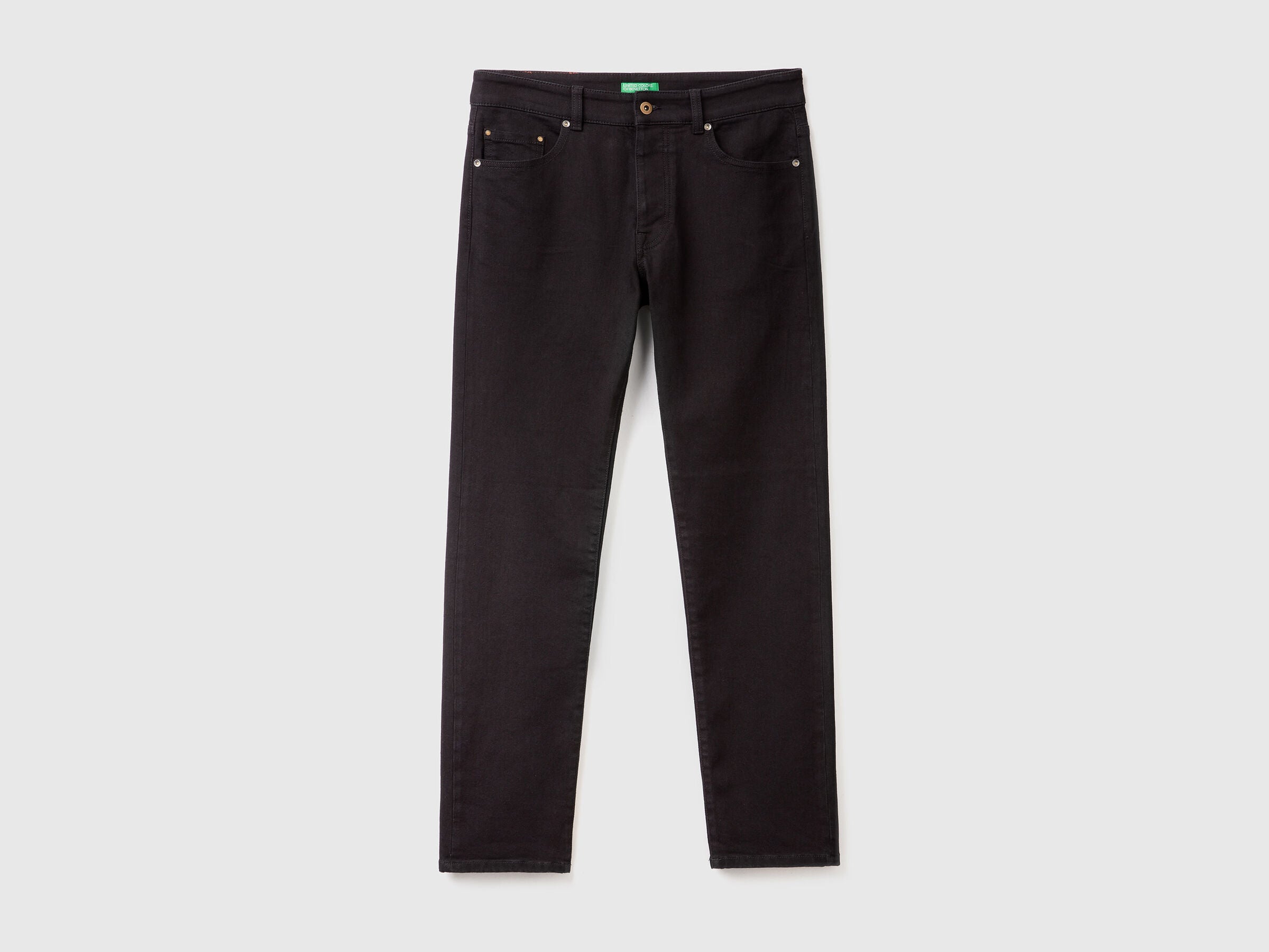 Close-up of the waistband, button, and pockets on a pair of men&