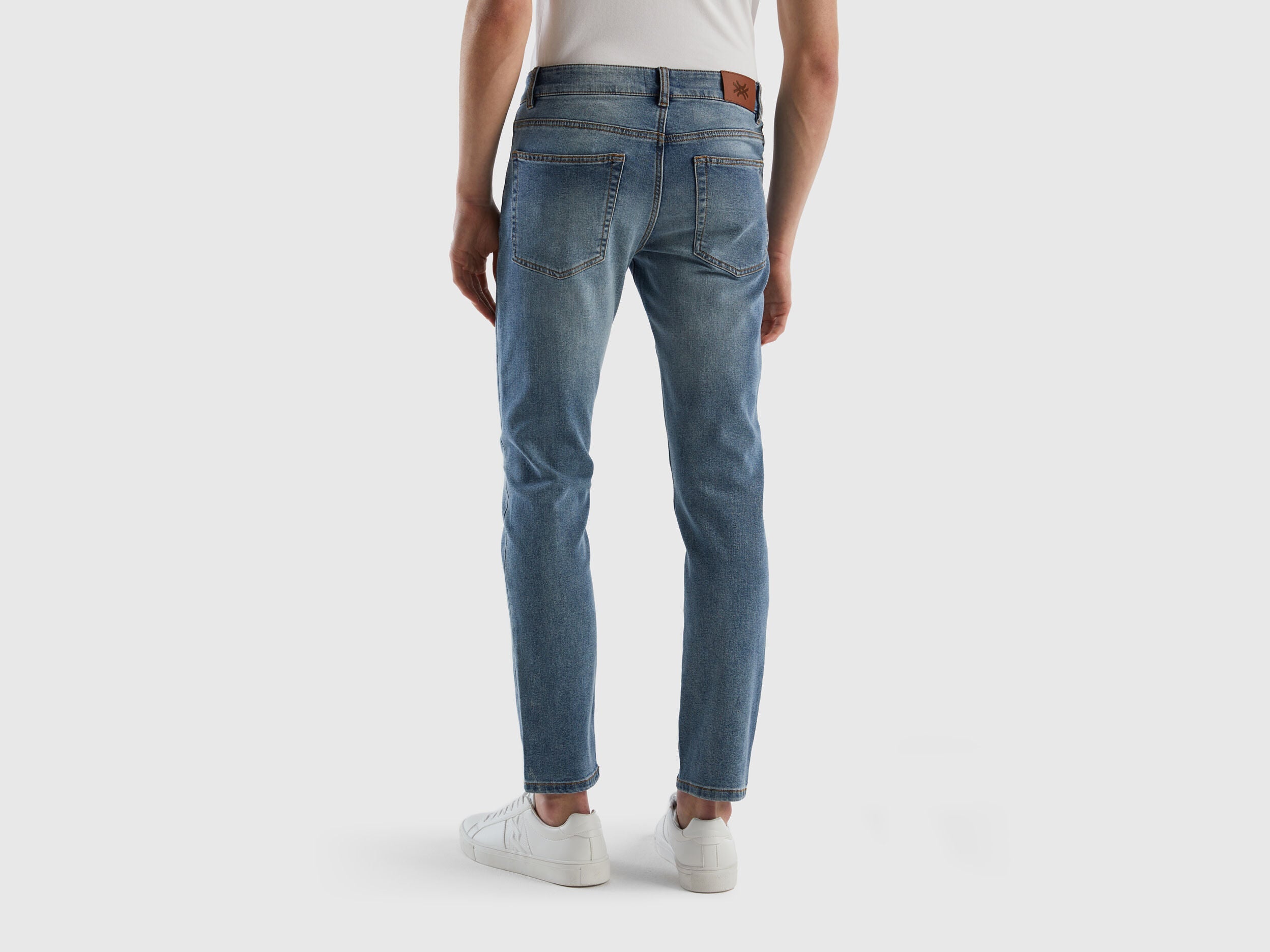 Flat lay front view of black slim-fit jeans for men.