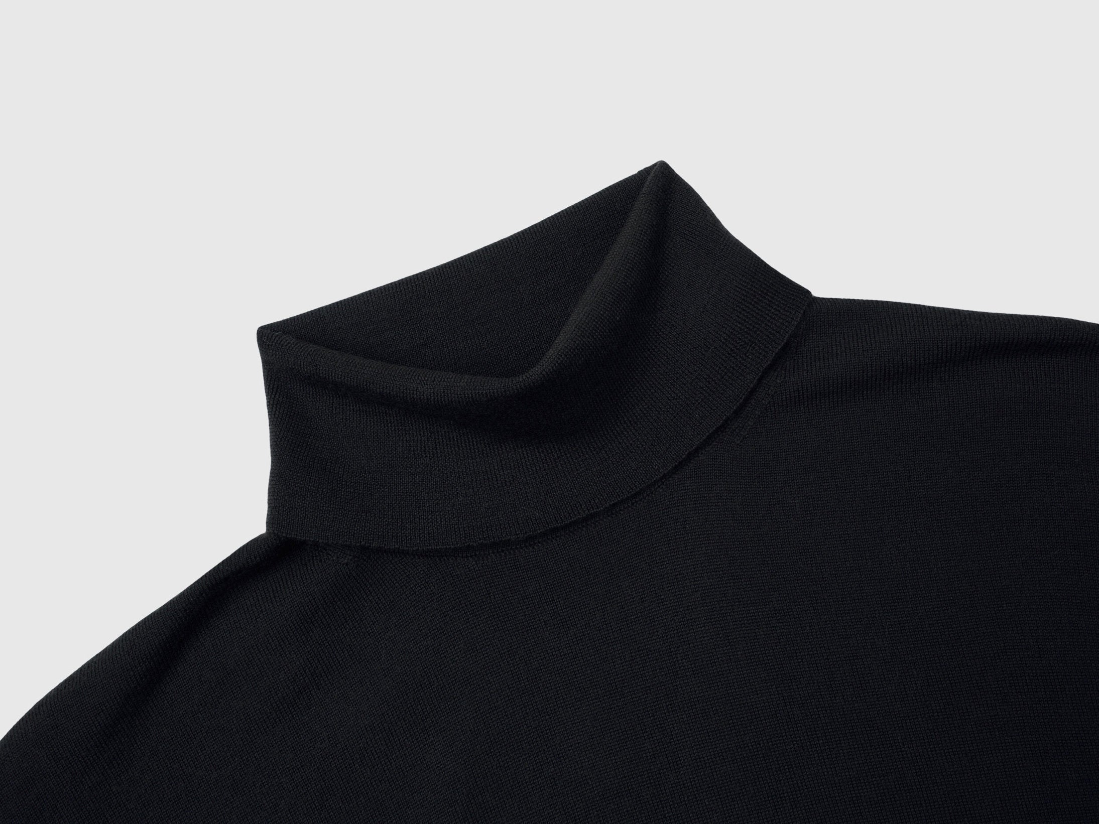 Close-up of the folded turtleneck collar on a black men&