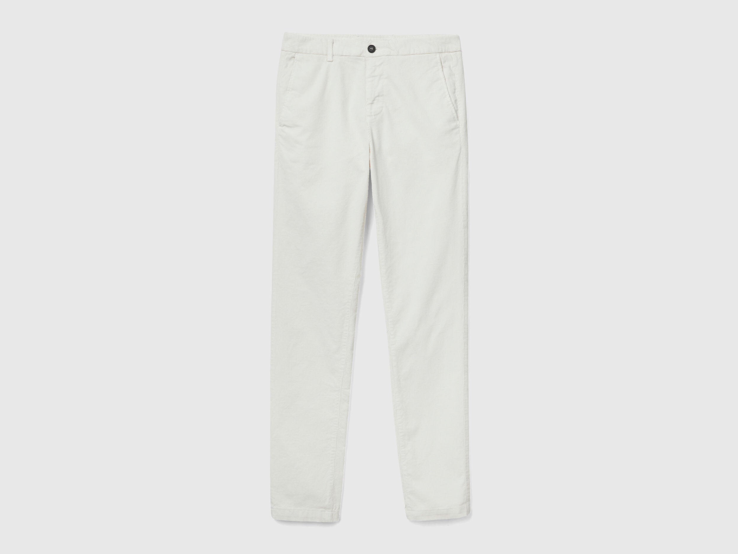 Flat lay, front view of a pair of plain white stretch velvet trousers, emphasizing the texture and design of velvet jeans for men in Kuwait.