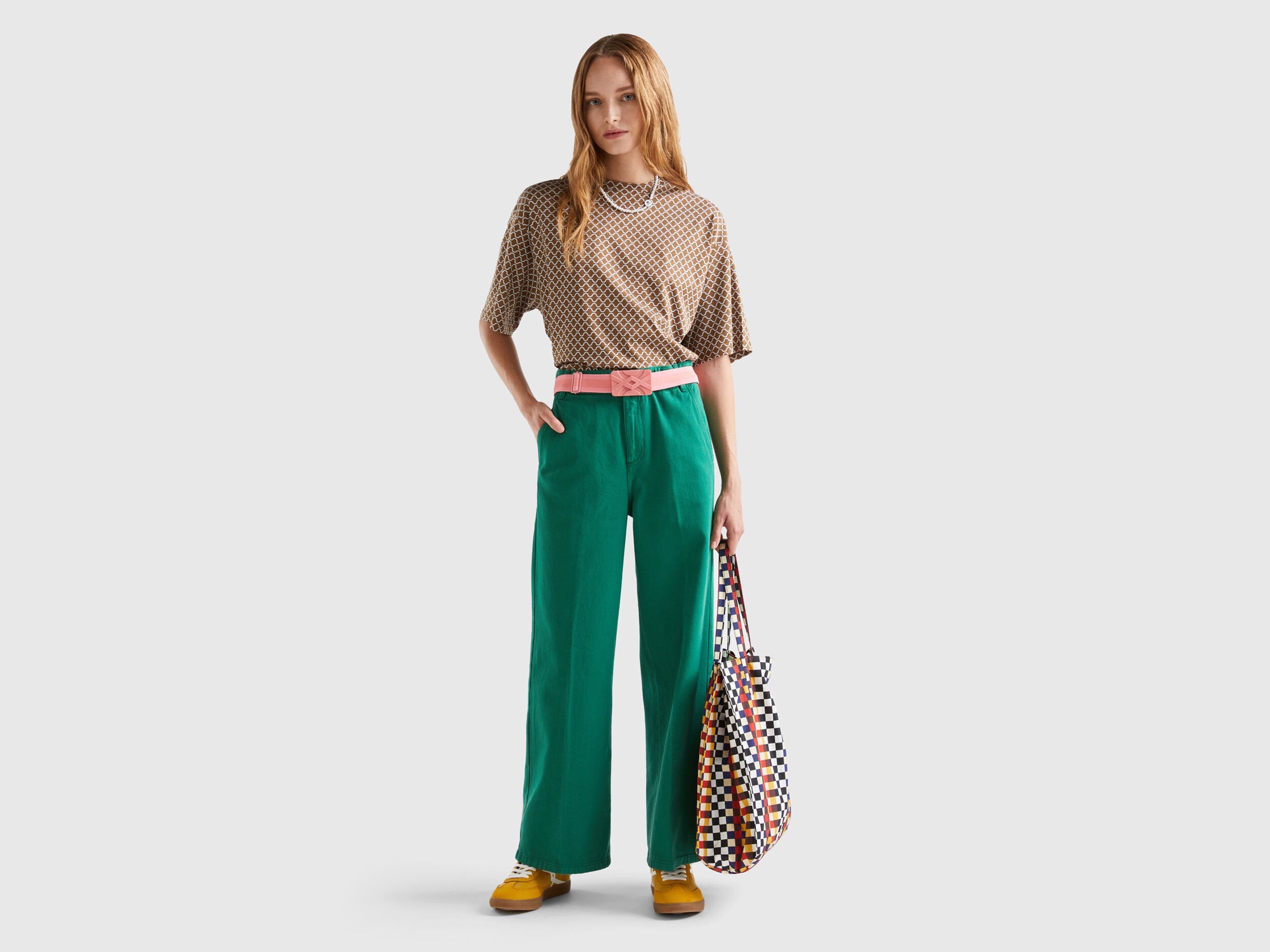 A female model showcasing wide-leg, green high-waisted trousers, an elegant and comfortable choice for high-waisted trousers & pants for women in Kuwait.