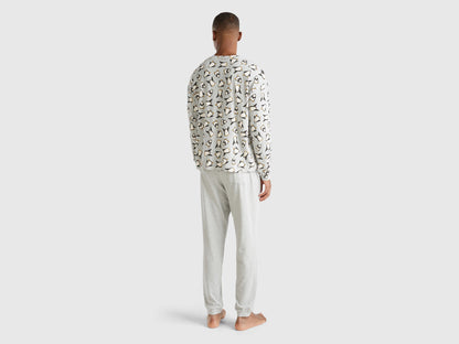 Full-length back view of a man wearing white pyjamas with a penguin print in Kuwait.
