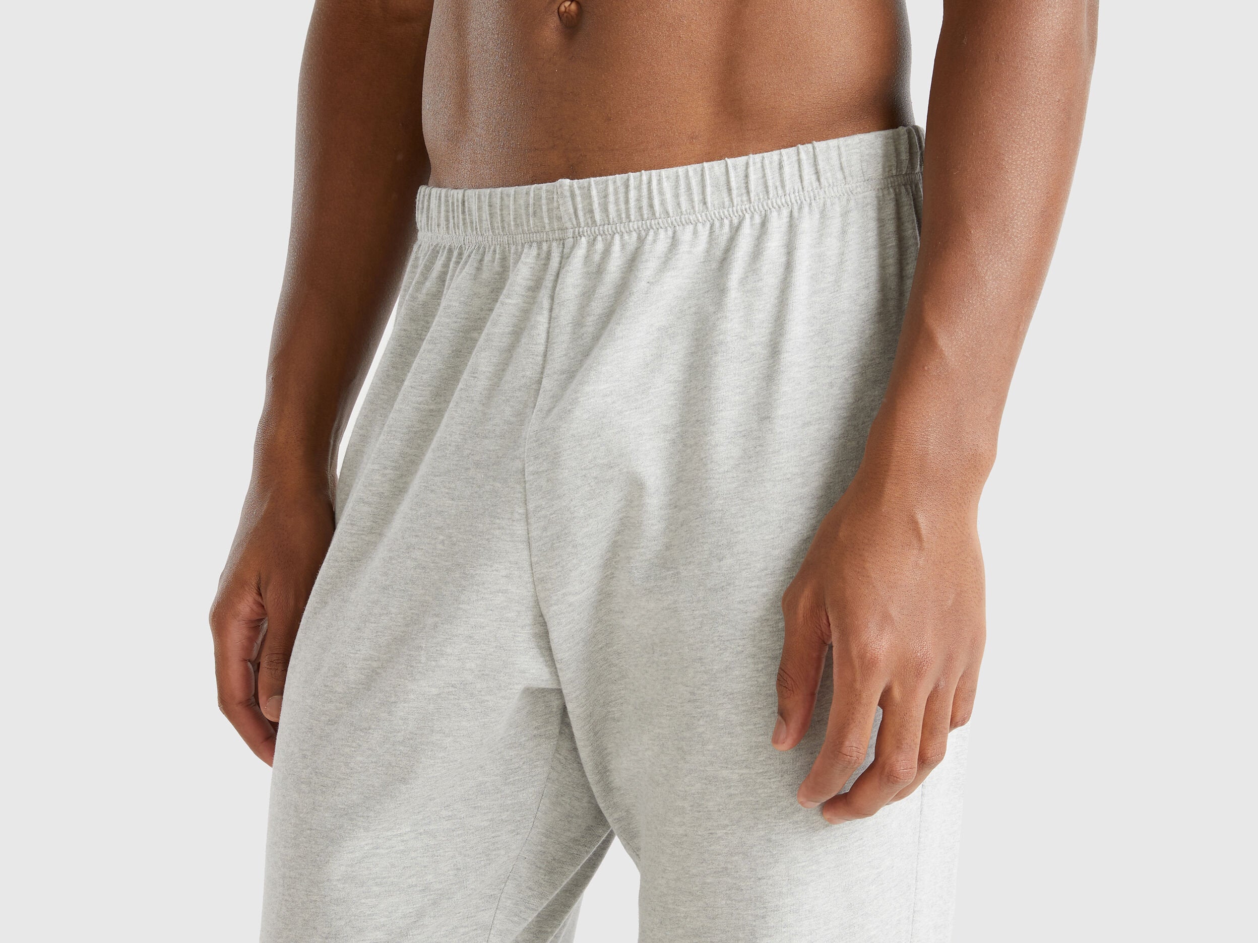 Close-up of the light grey pyjama bottoms for men, showing elastic waistband.