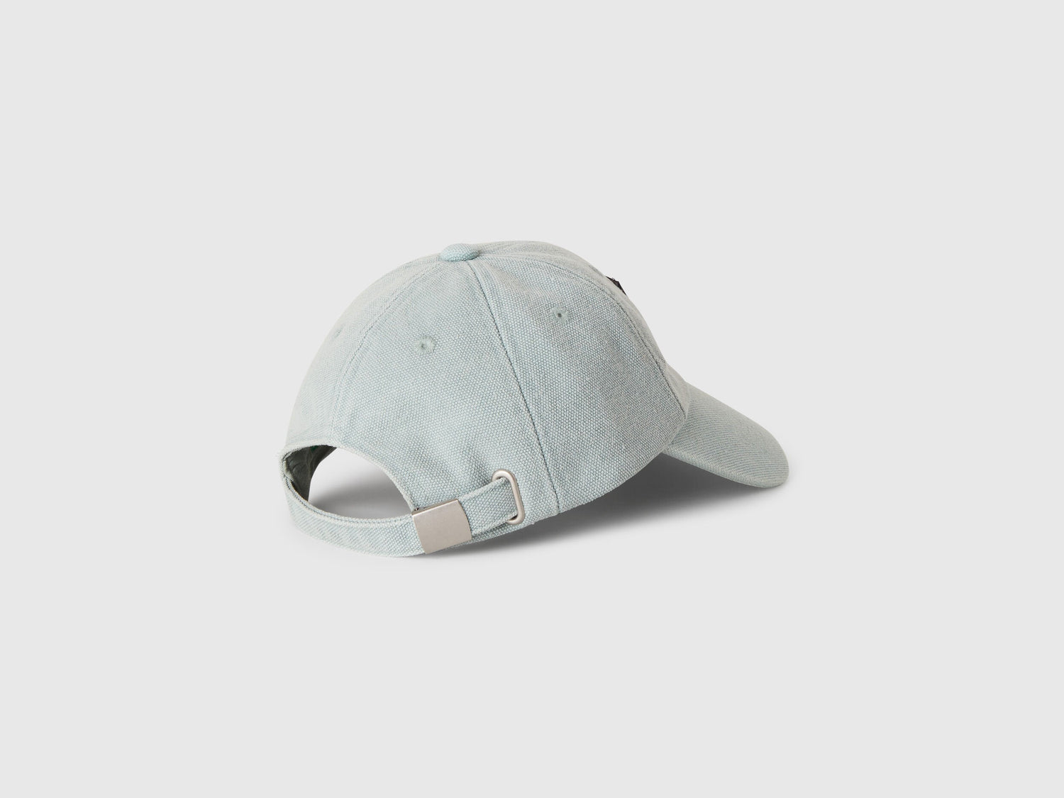 Back view of a male model wearing an branded baseball cap, showing the adjustable strap and brand detail.