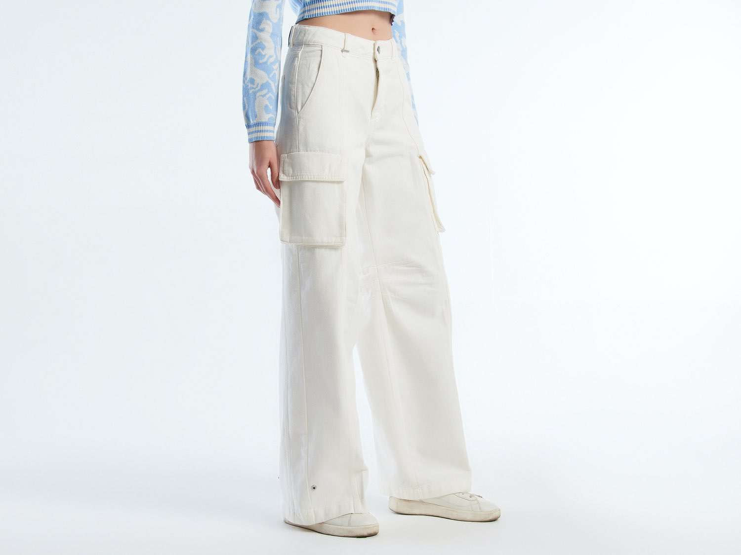 Angled front view of beige wide-leg cargo pants, highlighting the relaxed fit, suitable for the Kuwait climate.