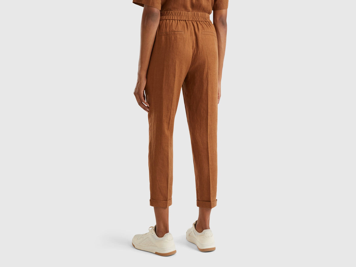 Side view of a female model wearing beige women&