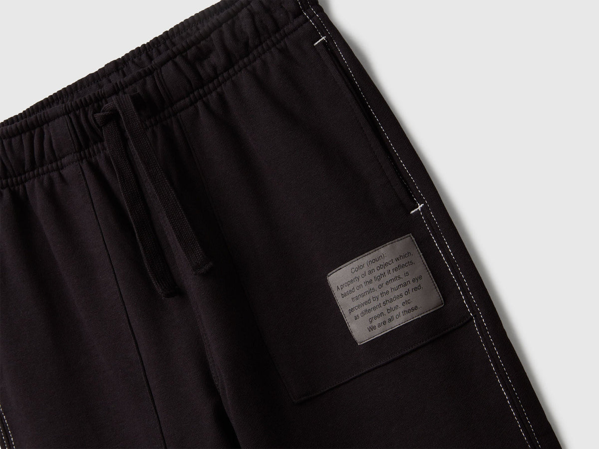 Back view of Benetton black joggers with pocket and logo tag