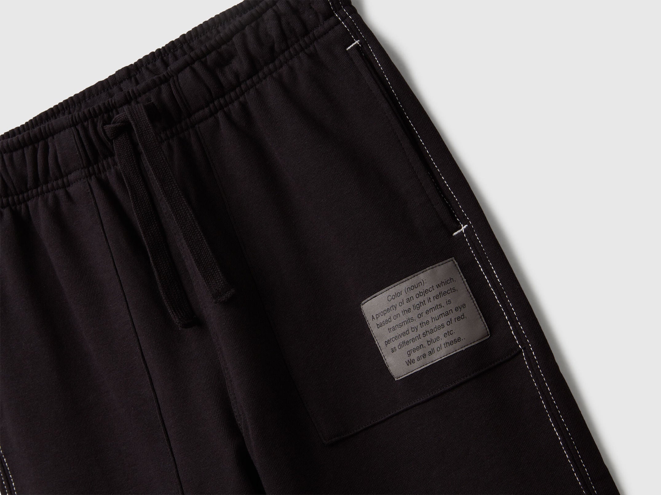 Back view of Benetton black joggers with pocket and logo tag