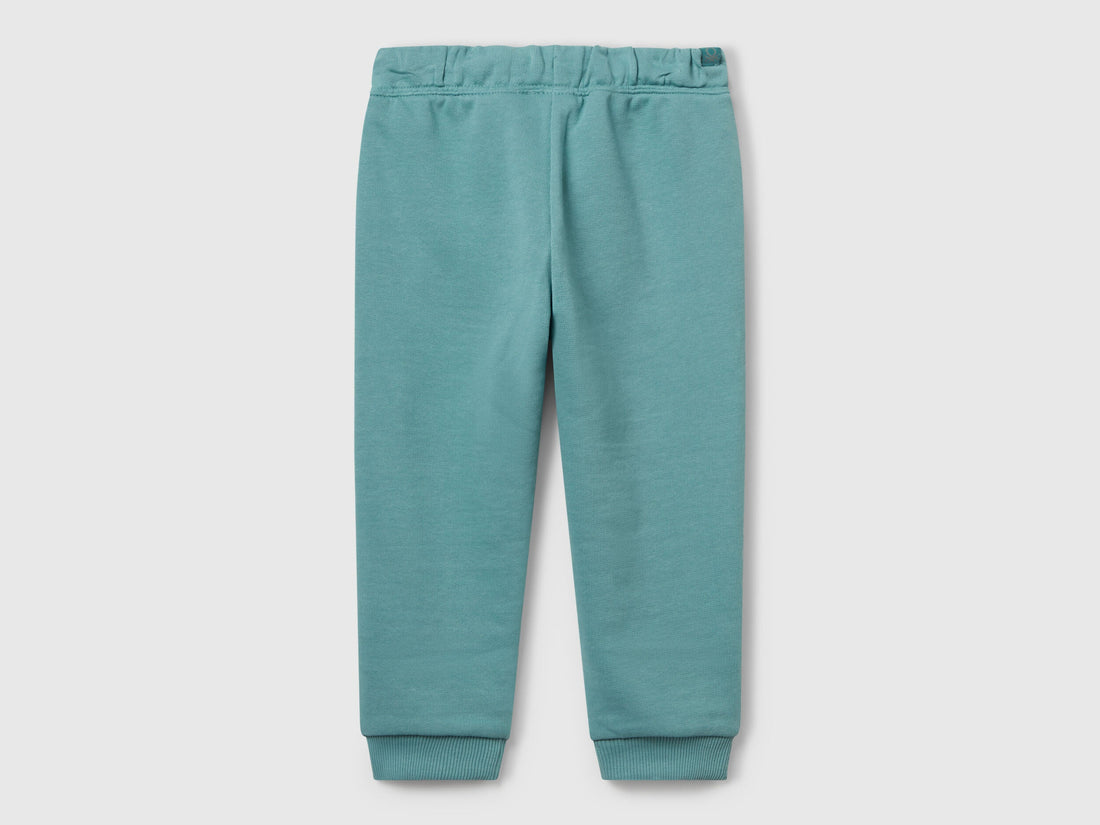 Benetton blue cotton joggers side view showing elastic waist detail