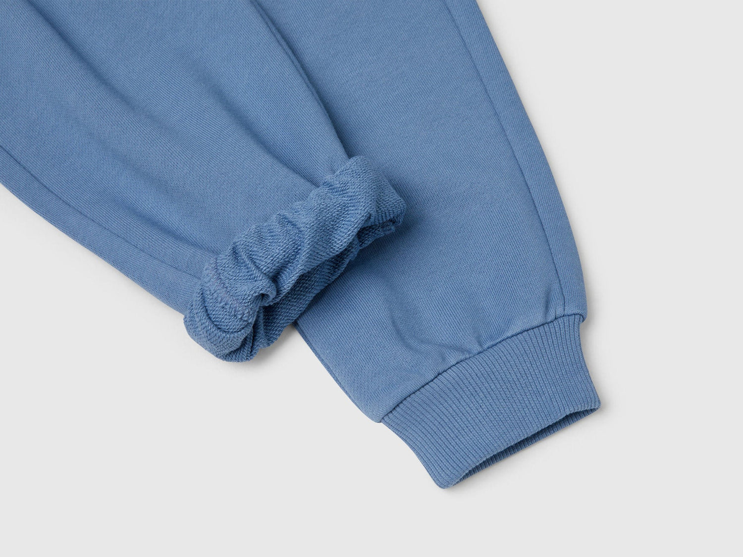 Benetton blue cotton sweatpants side view showing comfortable fit
