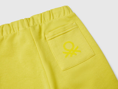 Benetton boys green organic cotton sweatpants with logo side view.