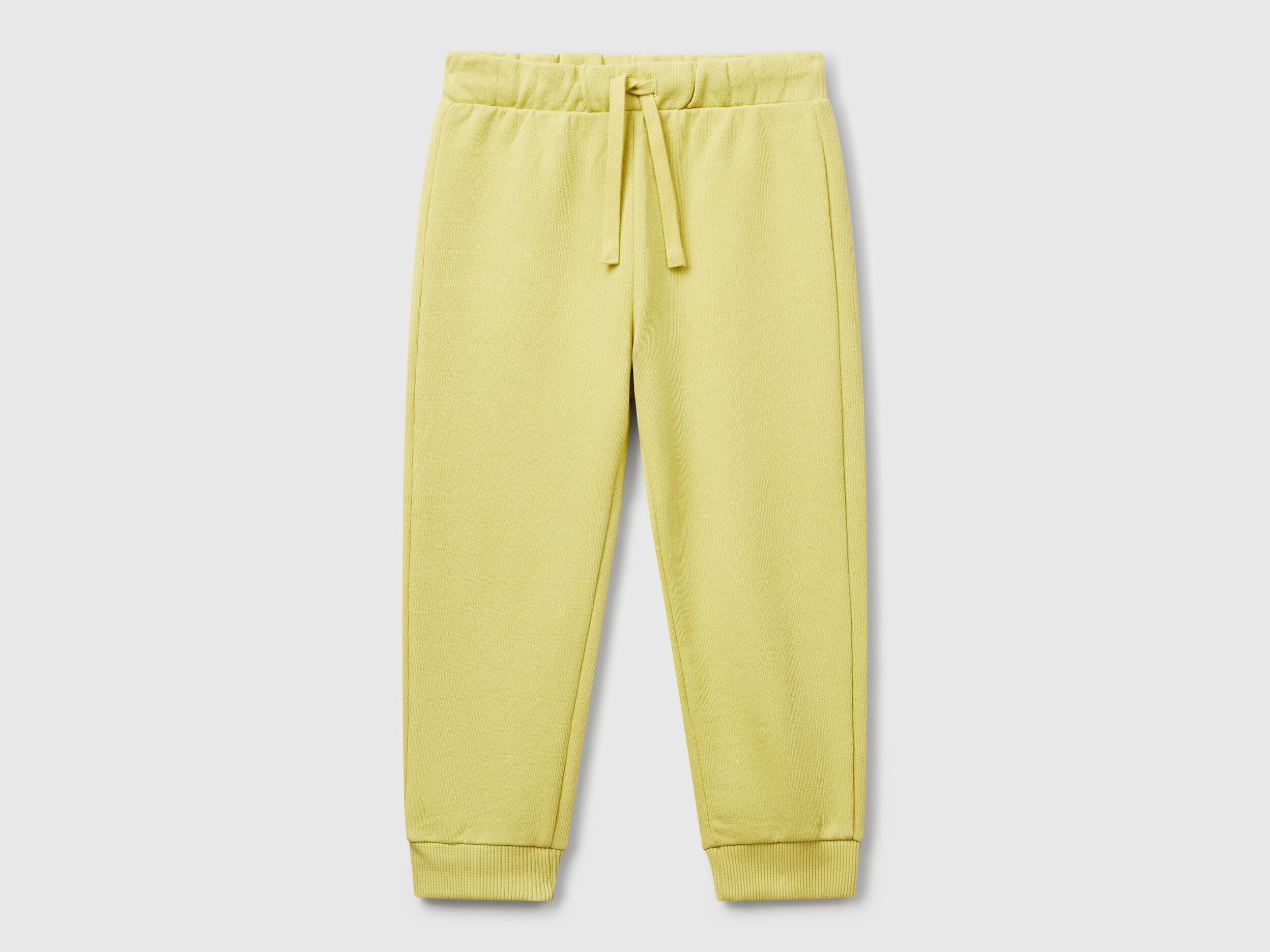 Benetton boys yellow organic cotton trousers front view with drawstring waist