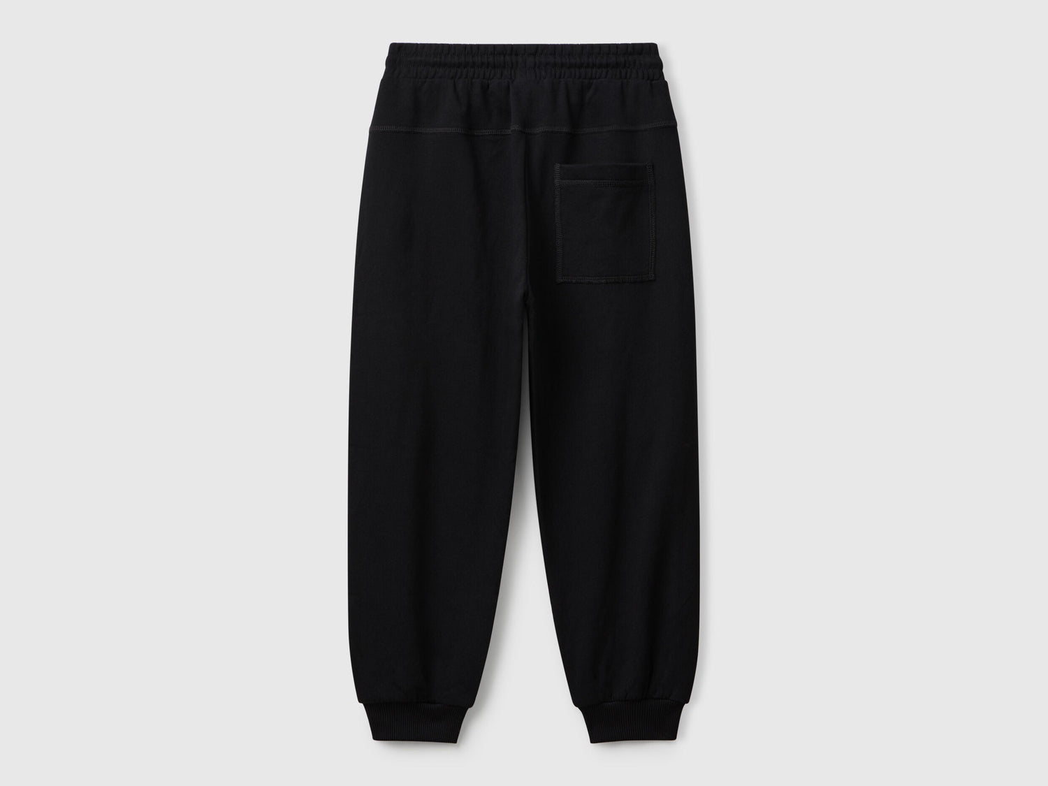 Back view of Benetton graffiti print sweatpants with patch pocket and logo detail