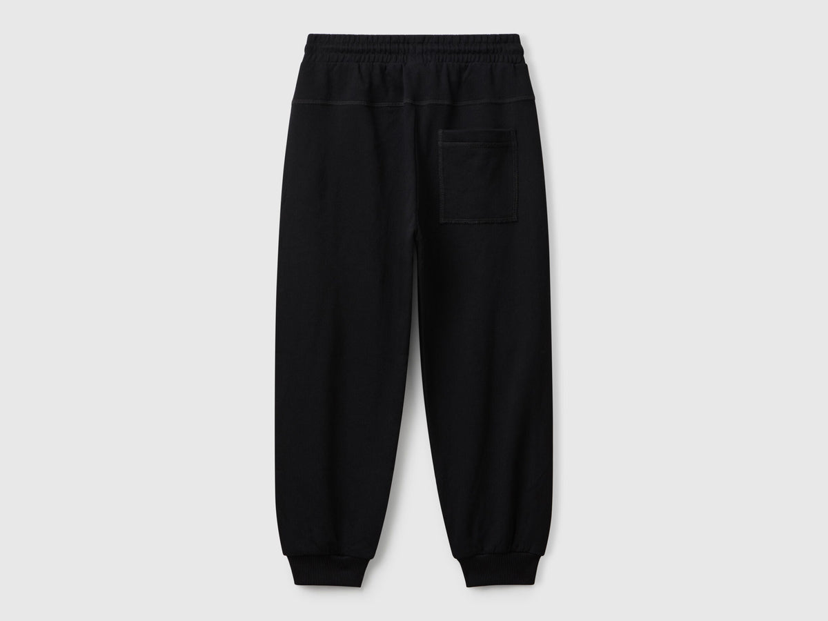 Back view of Benetton graffiti print sweatpants with patch pocket and logo detail