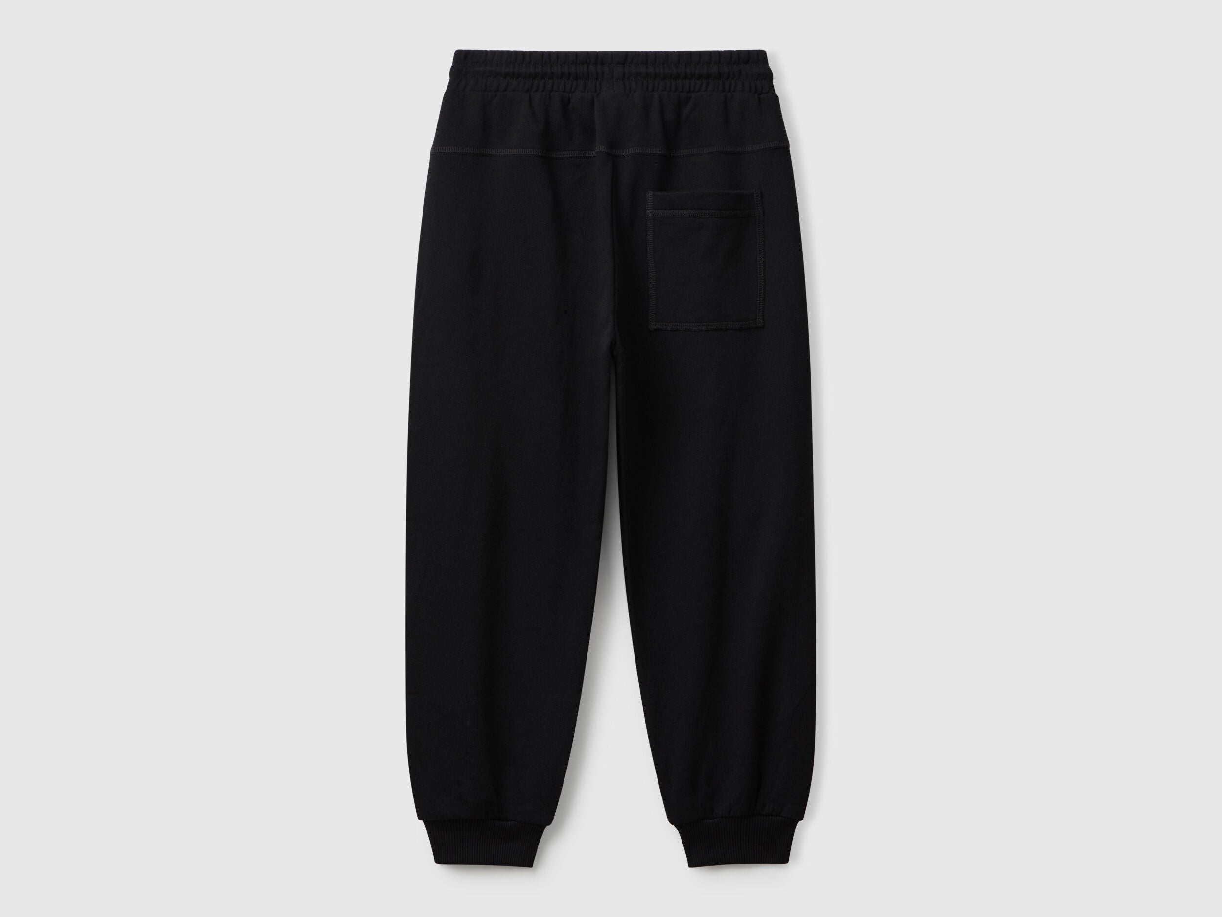 Back view of Benetton graffiti print sweatpants with patch pocket and logo detail