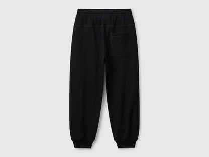Back view of Benetton graffiti print sweatpants with patch pocket and logo detail