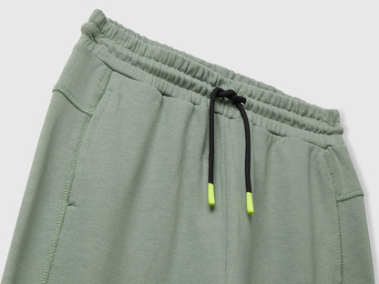 Benetton green cotton sweatpants side view showing elastic bottom and fit