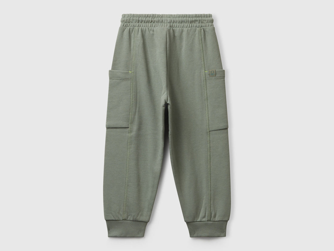 Benetton green cotton sweatpants side view showing patch detail
