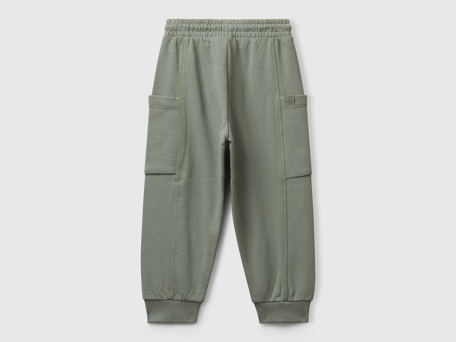 Benetton green cotton sweatpants side view showing patch detail
