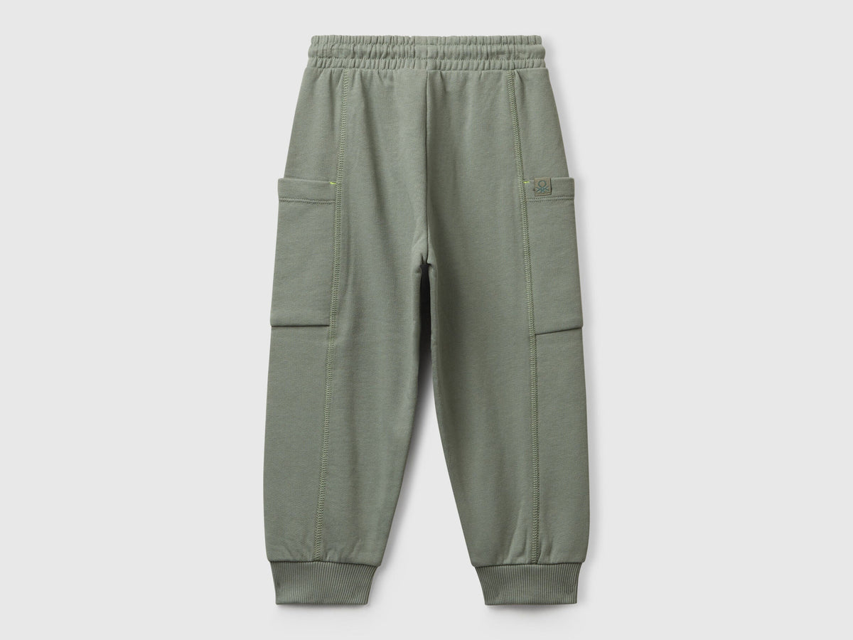 Benetton green cotton sweatpants side view showing patch detail