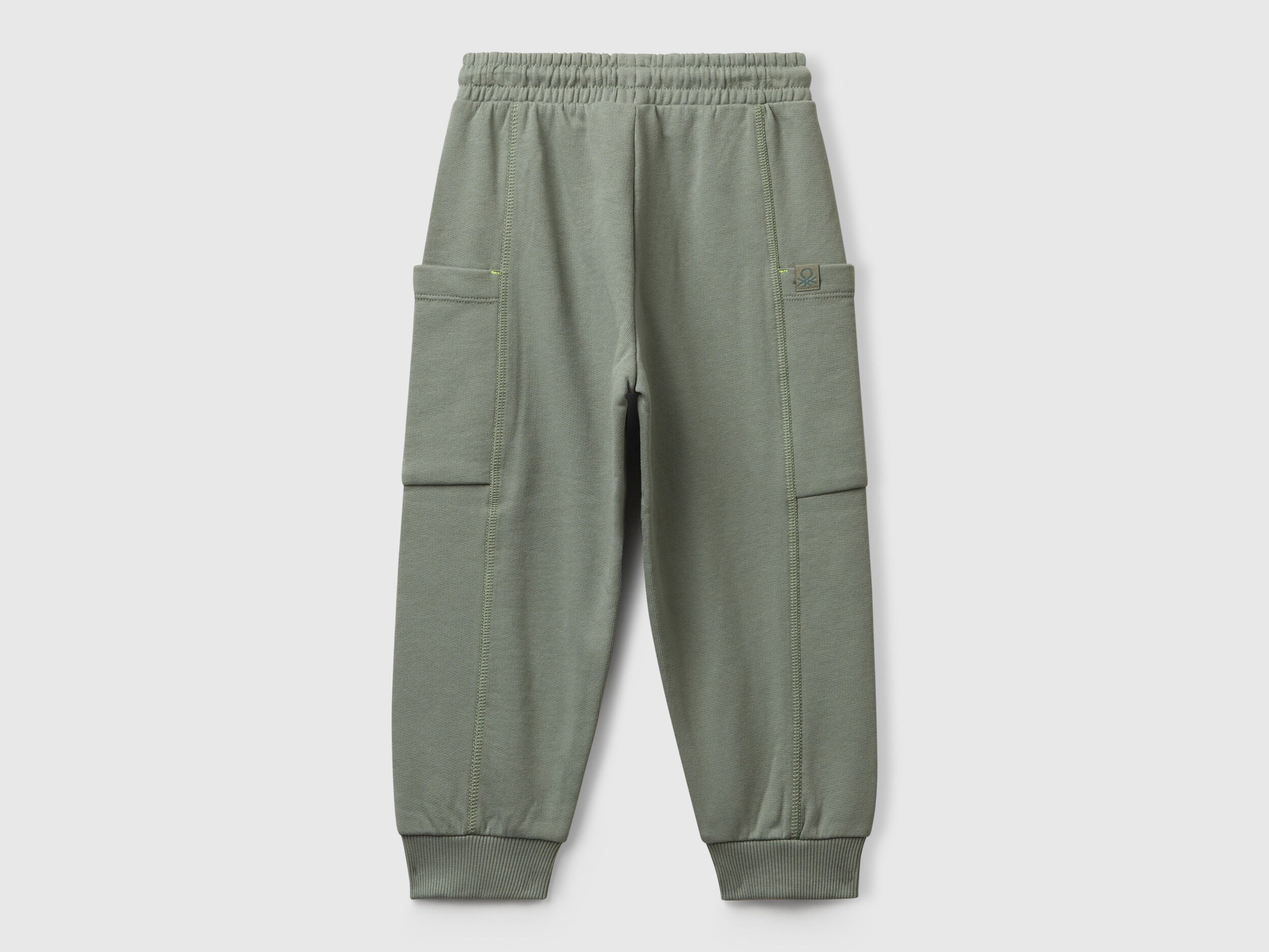 Benetton green cotton sweatpants side view showing patch detail