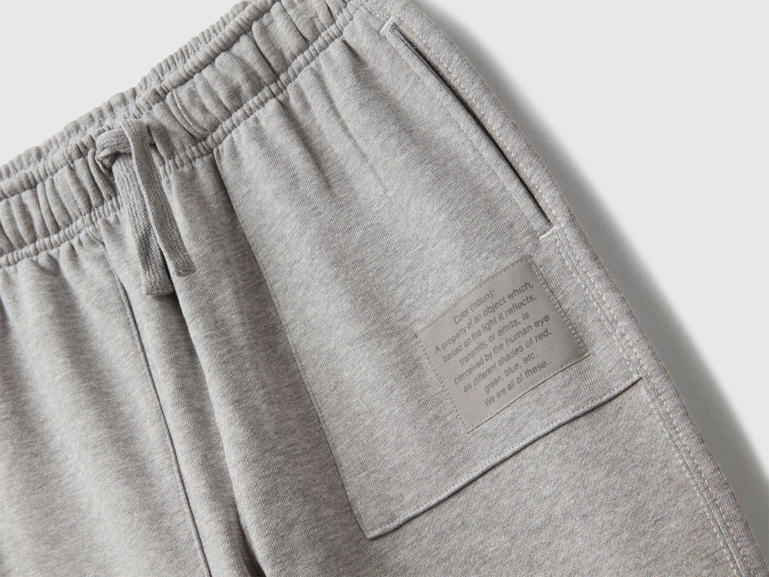 Back view of Benetton grey joggers with back pocket and logo tag