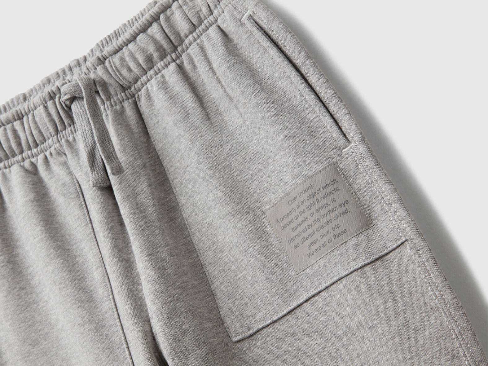 Back view of Benetton grey joggers with back pocket and logo tag