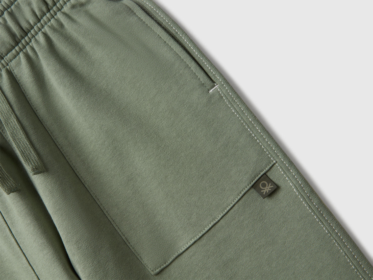Close-up of Benetton joggers elastic waist and logo detail